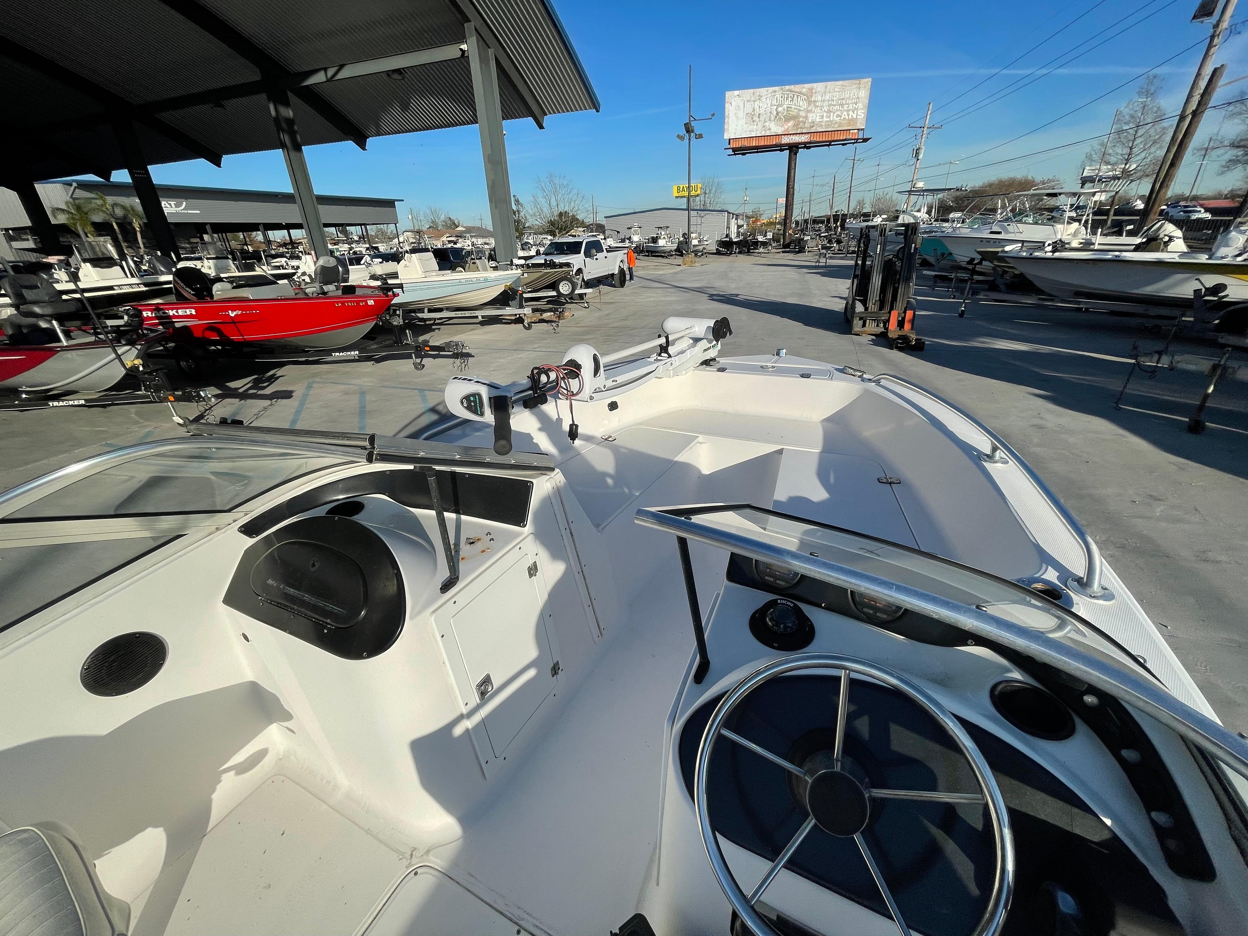 2002 Angler 18 DC boat interior at a dealership, surrounded by other boats.