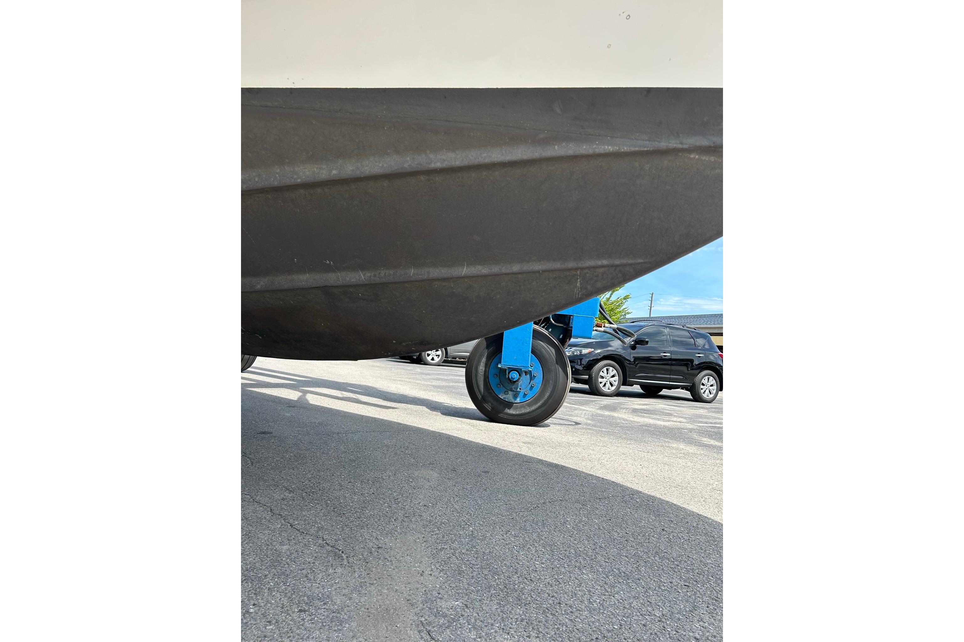 2019 Monterey 335 Sport Yacht on trailer, parked in a lot with cars.