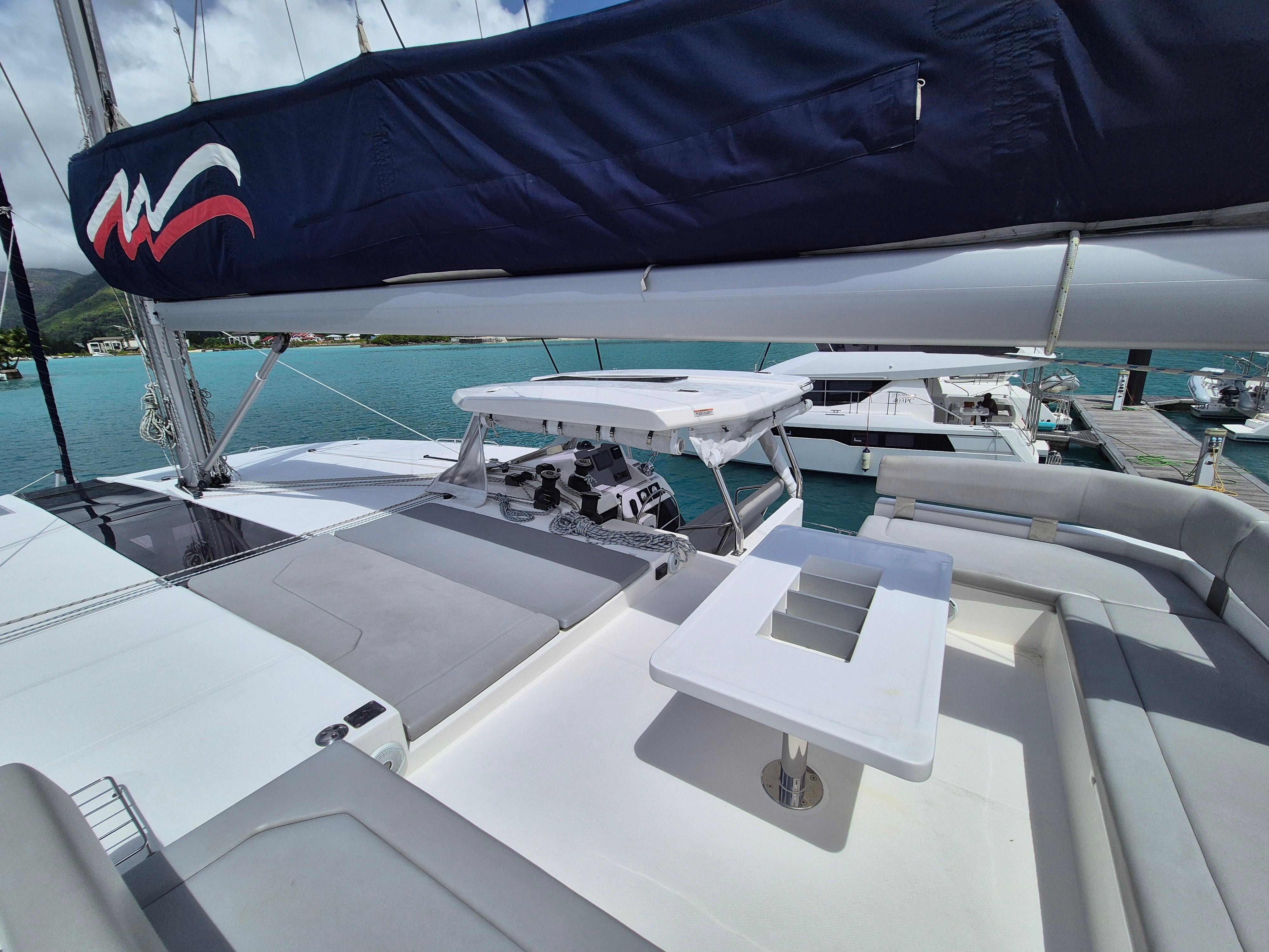 Leopard 50 catamaran deck with seating and table, docked in a marina, 2020 model.