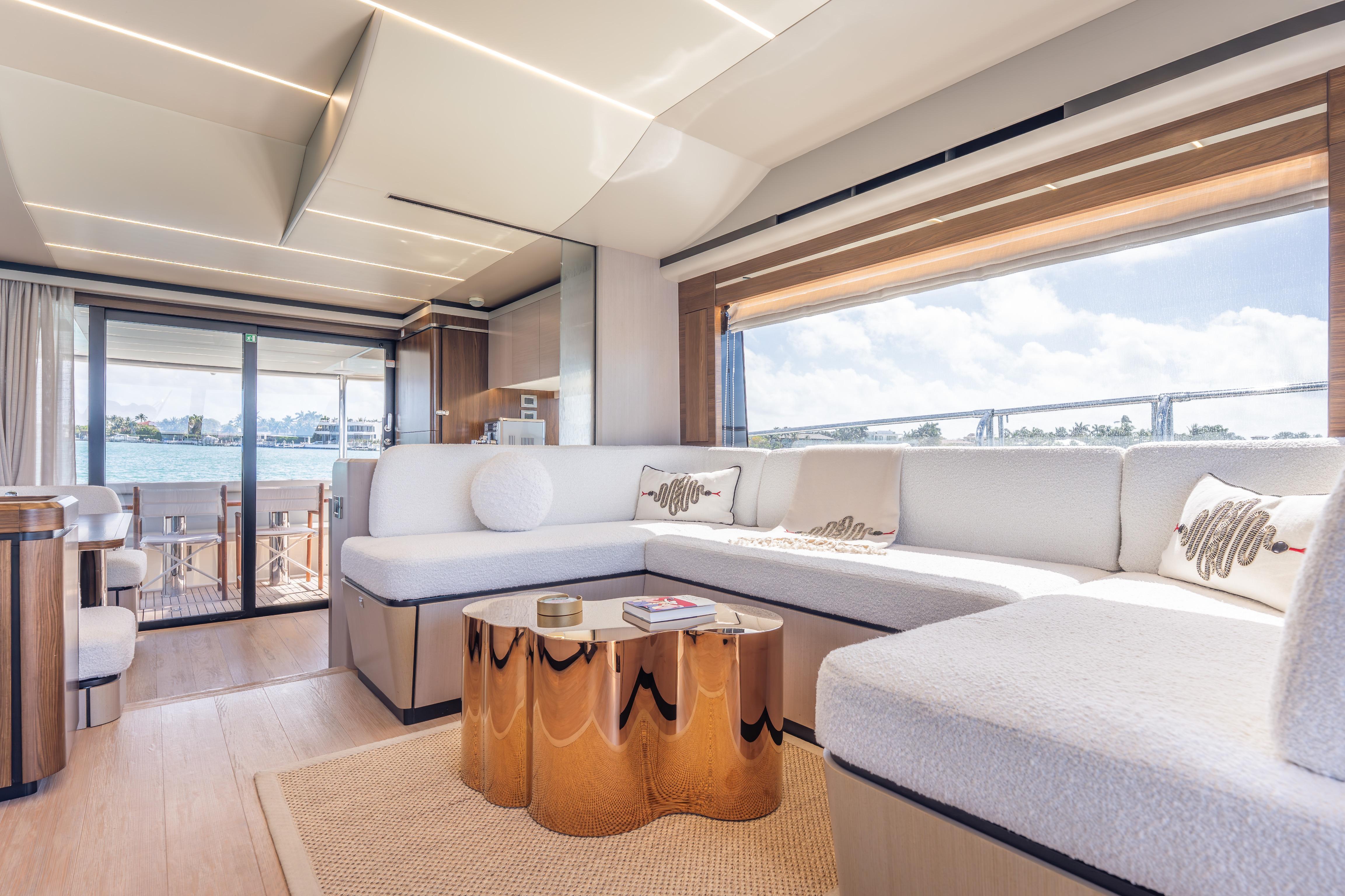 Luxurious interior of 2019 Absolute 58 FLY yacht with elegant seating and panoramic windows.