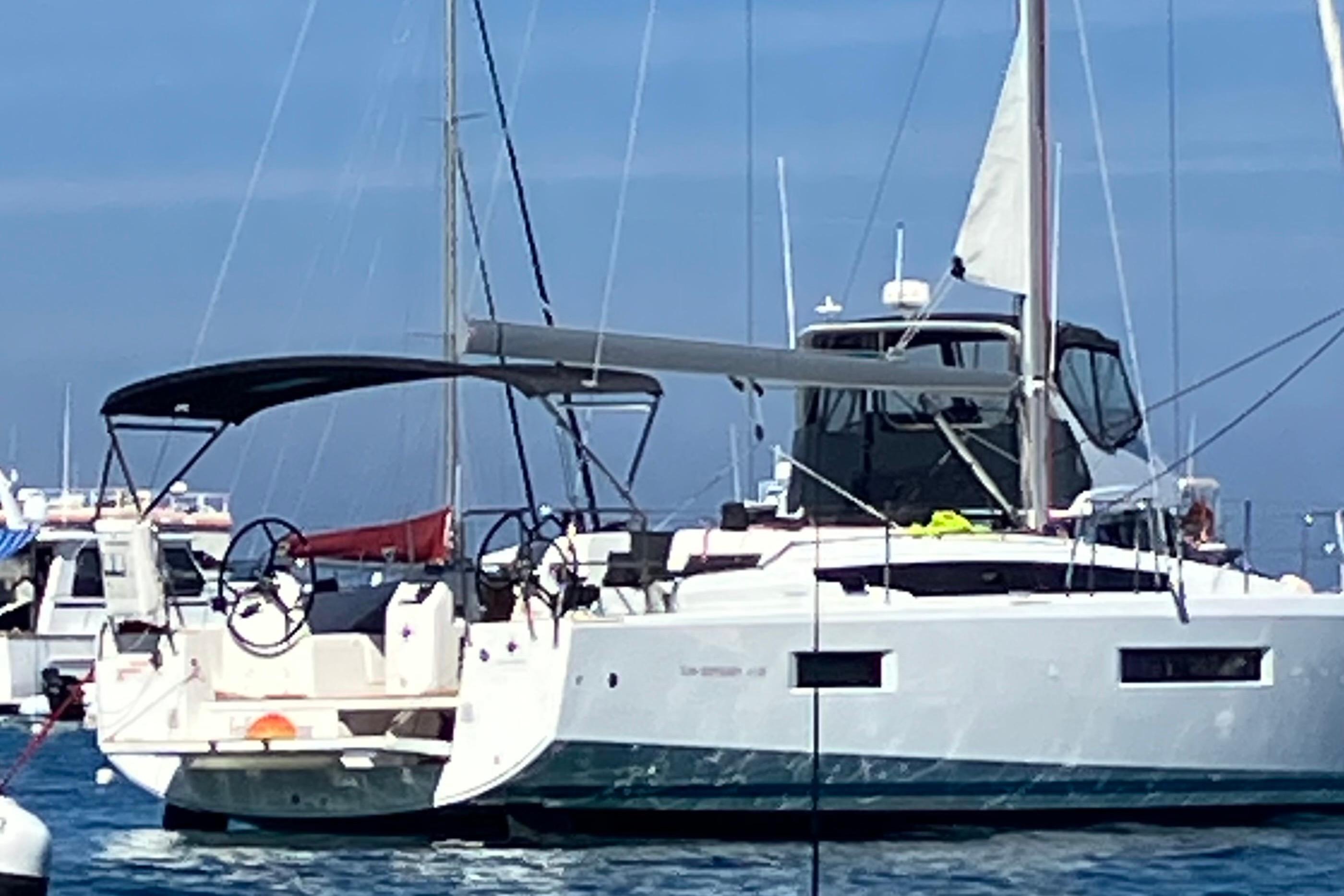 2024 Jeanneau Sun Odyssey 410 sailboat docked in a marina, featuring sleek design and modern amenities.