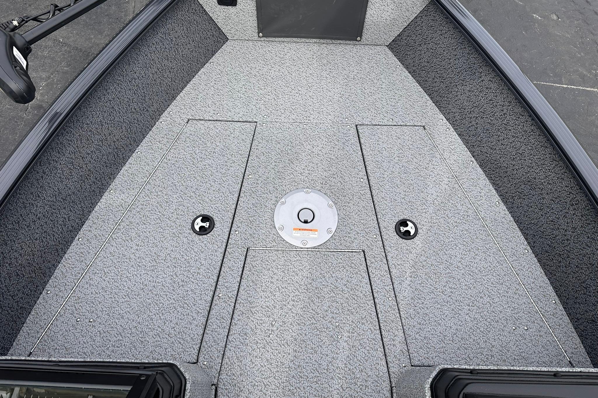 2026 Lund 1775 Adventure Sport boat deck with storage compartments and textured flooring.