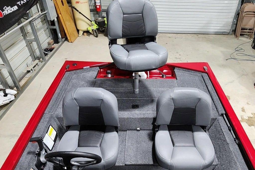 2026 Tracker Pro 170 boat interior with three gray seats in a garage setting.