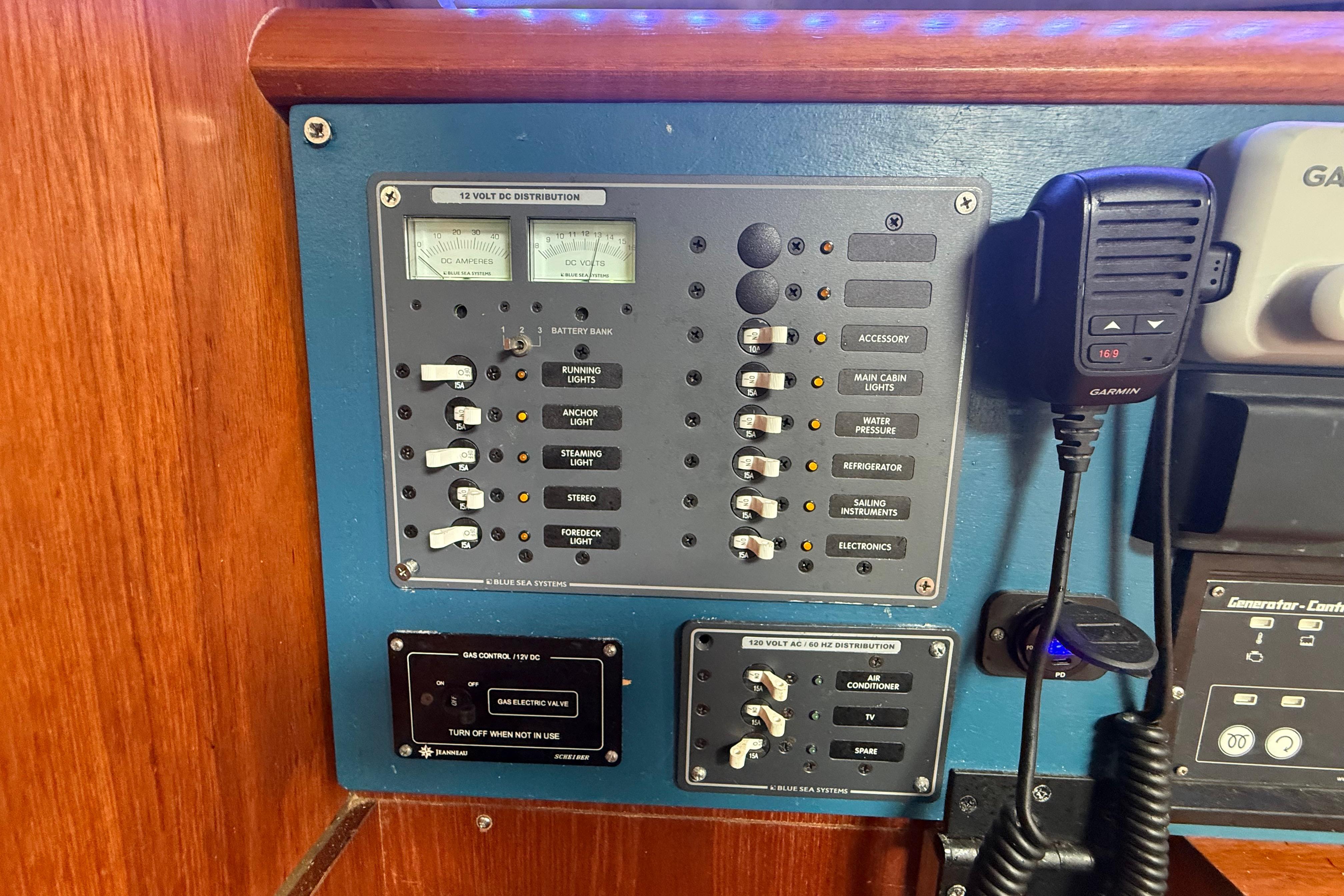 Control panel of a 2003 Jeanneau Sun Odyssey 37 sailboat with various switches and gauges.