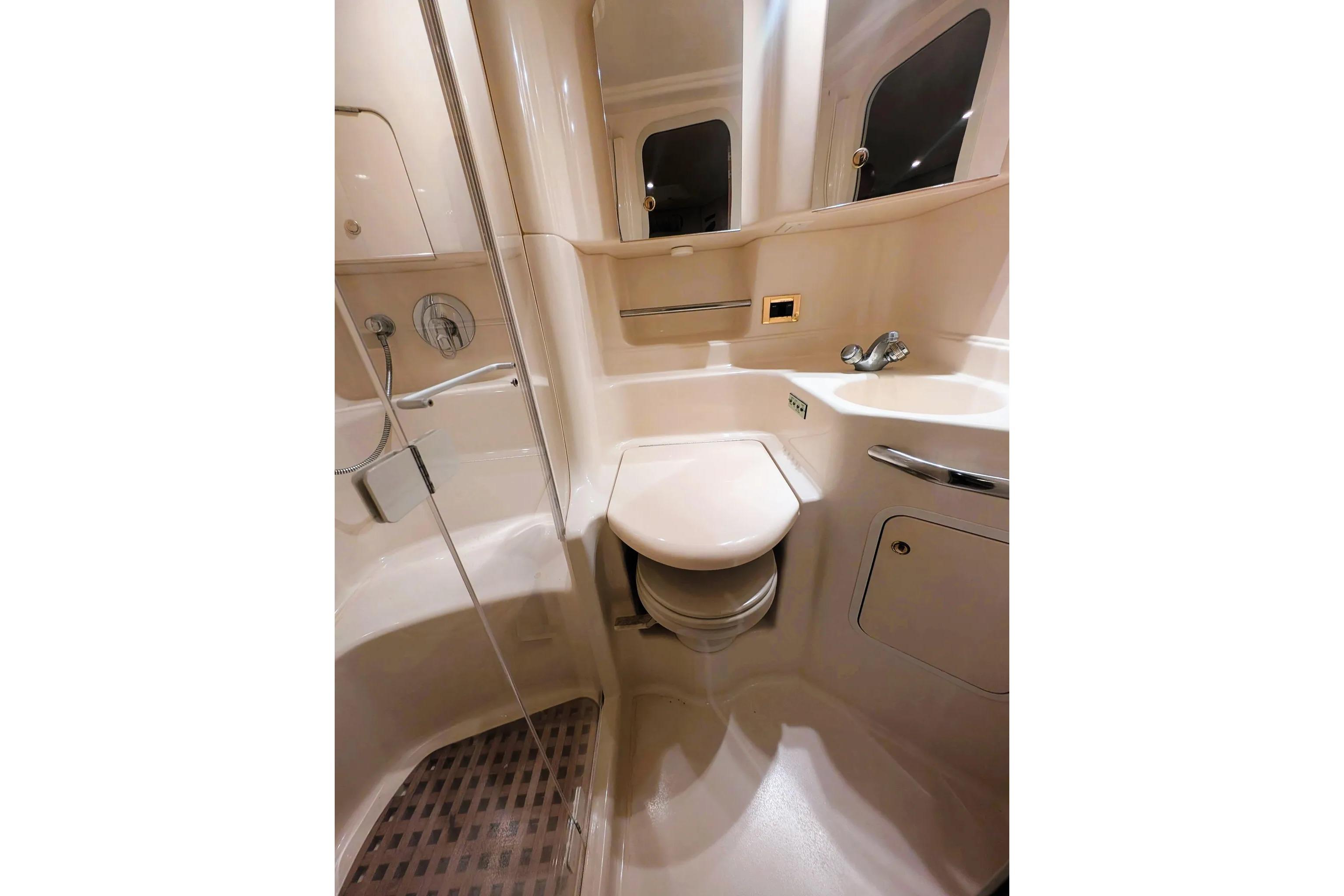 Bathroom interior of 2000 Sea Ray 380 Sundancer yacht, featuring compact design and modern fixtures.