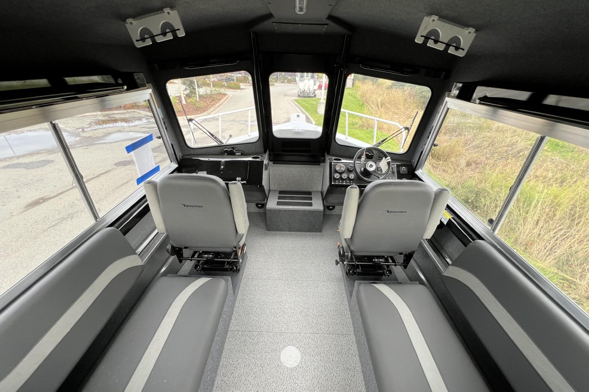 Interior of 2024 Spartan 220 Maximus boat with modern seating and dashboard.