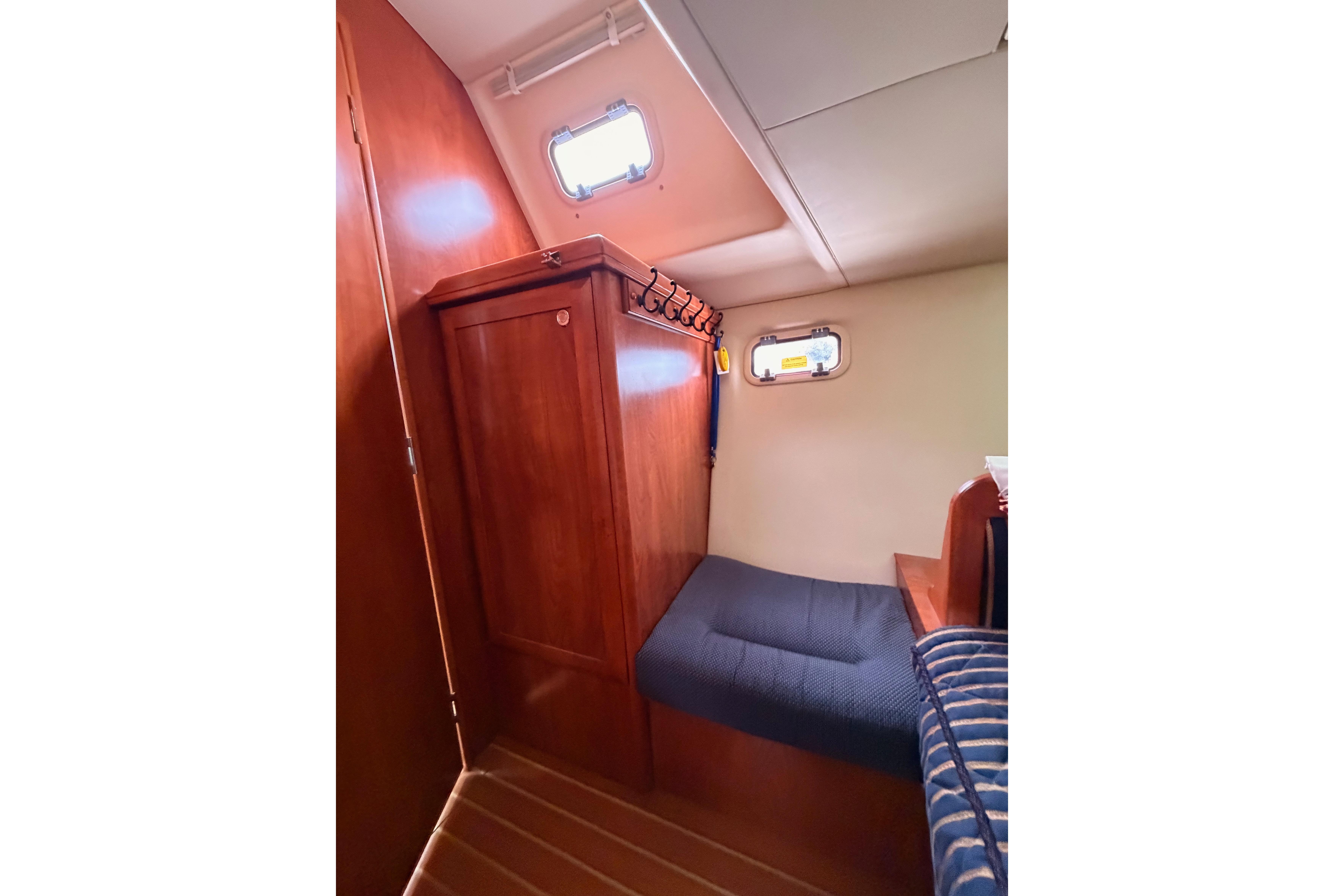 2009 Hunter 38 yacht interior cabin with wooden cabinetry and cozy seating.