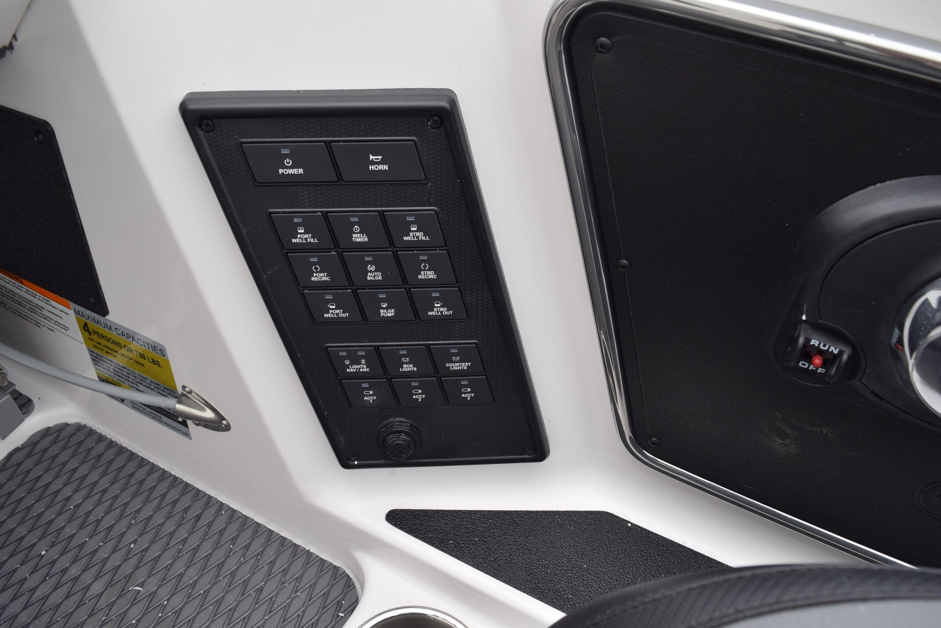 Control panel of 2027 Cayams CX 20 PRo boat with switches and ignition.