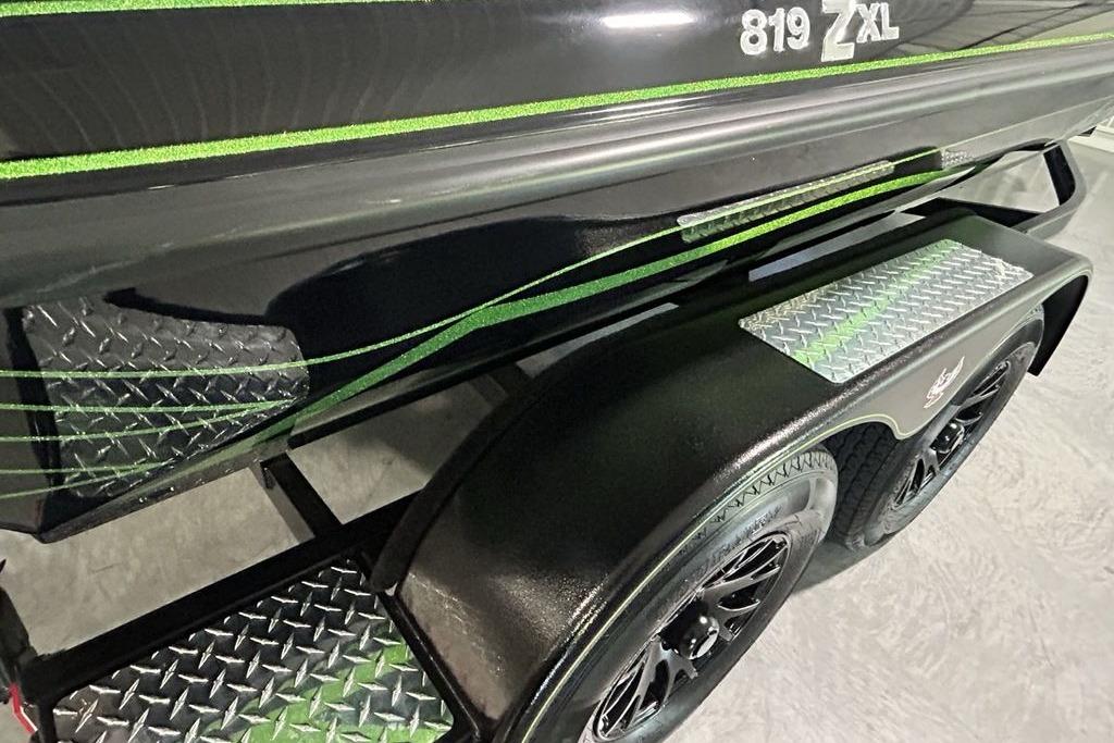 2026 Phoenix 819 ZXL boat trailer with green accents and diamond plate steps.