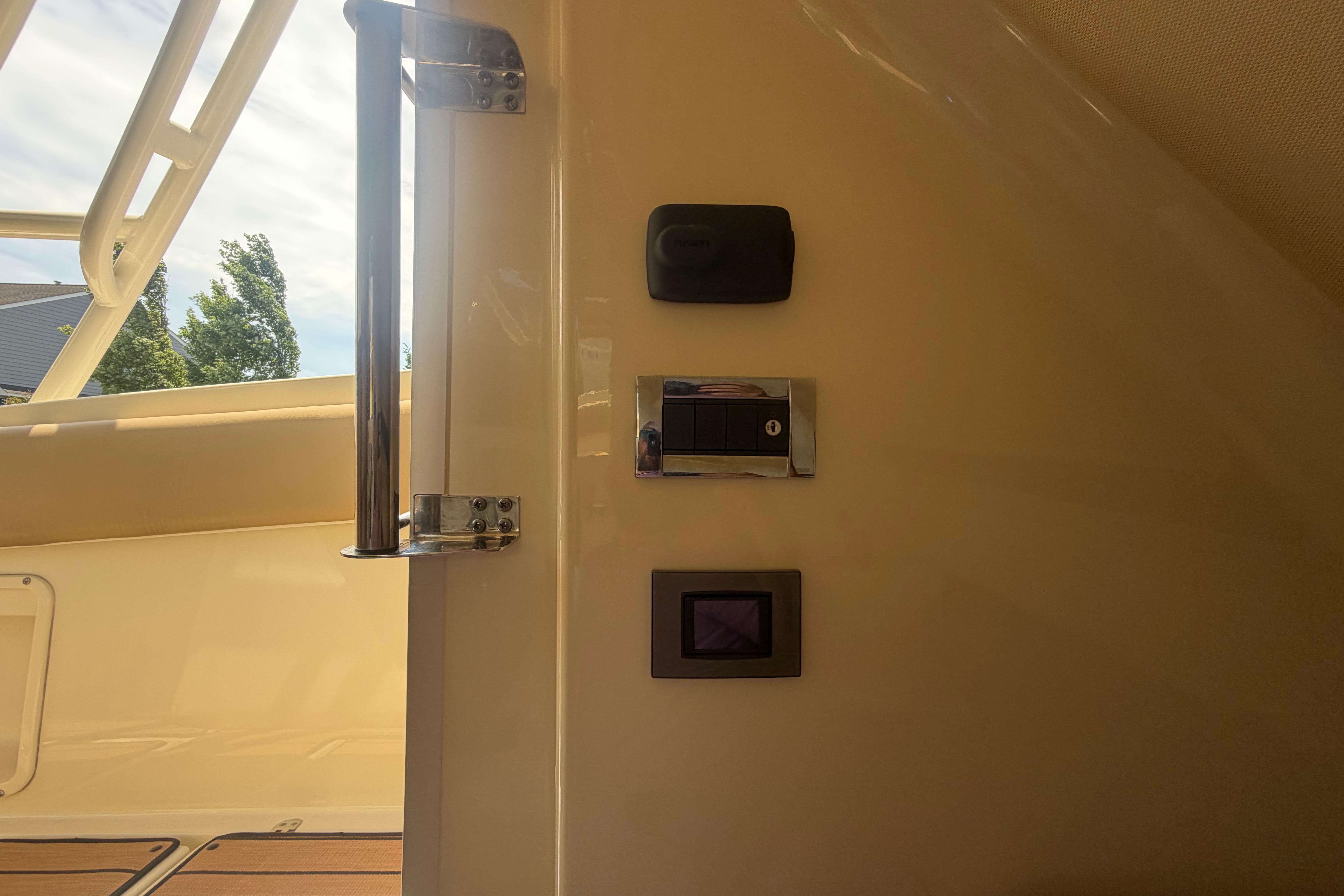Interior view of 2017 Chris-Craft Catalina 34 boat with control panel and railing.