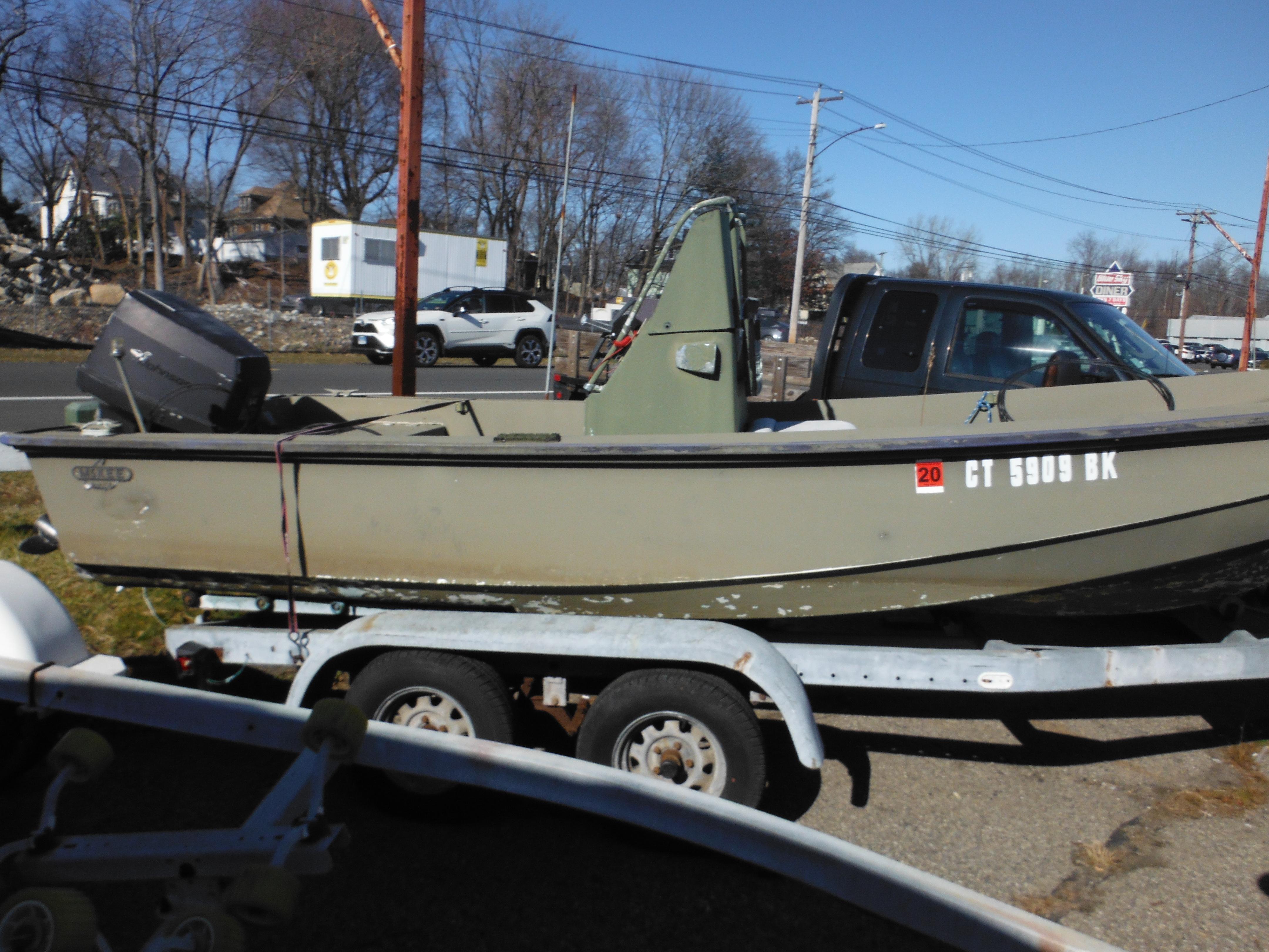1977 McKee Craft 17S boat on trailer, side view, parked outdoors.