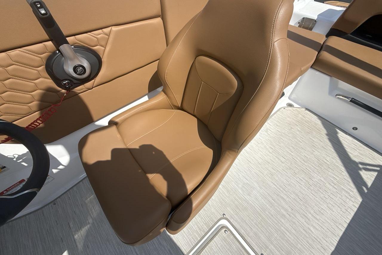 2024 Four Winns H1 OB boat interior with tan leather seat and steering controls.