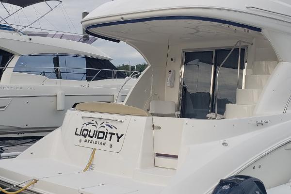 2010 Meridian 441 Sedan yacht docked, featuring spacious deck and sleek design.