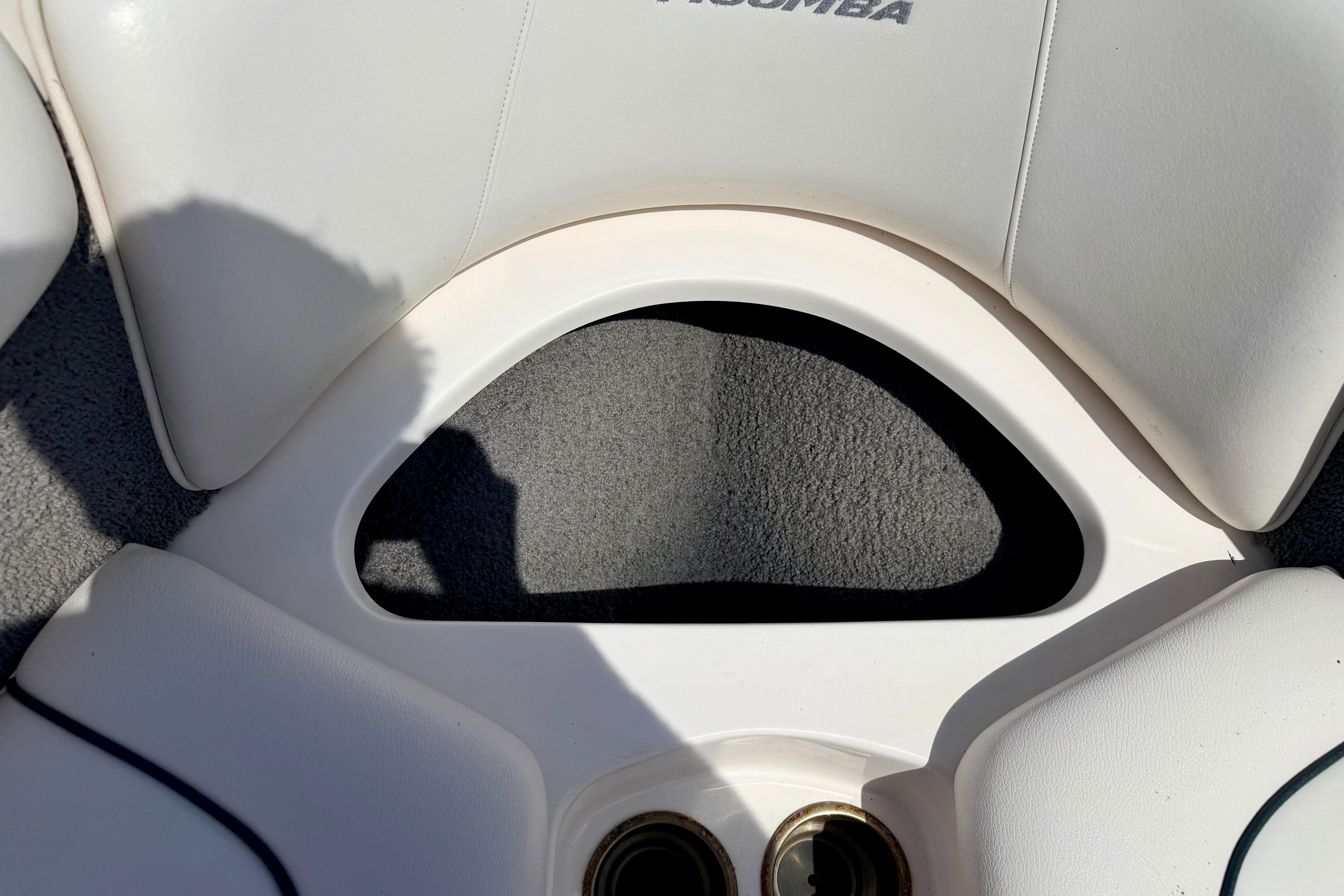 2008 Moomba Outback V boat interior with white cushioned seating and cup holders.