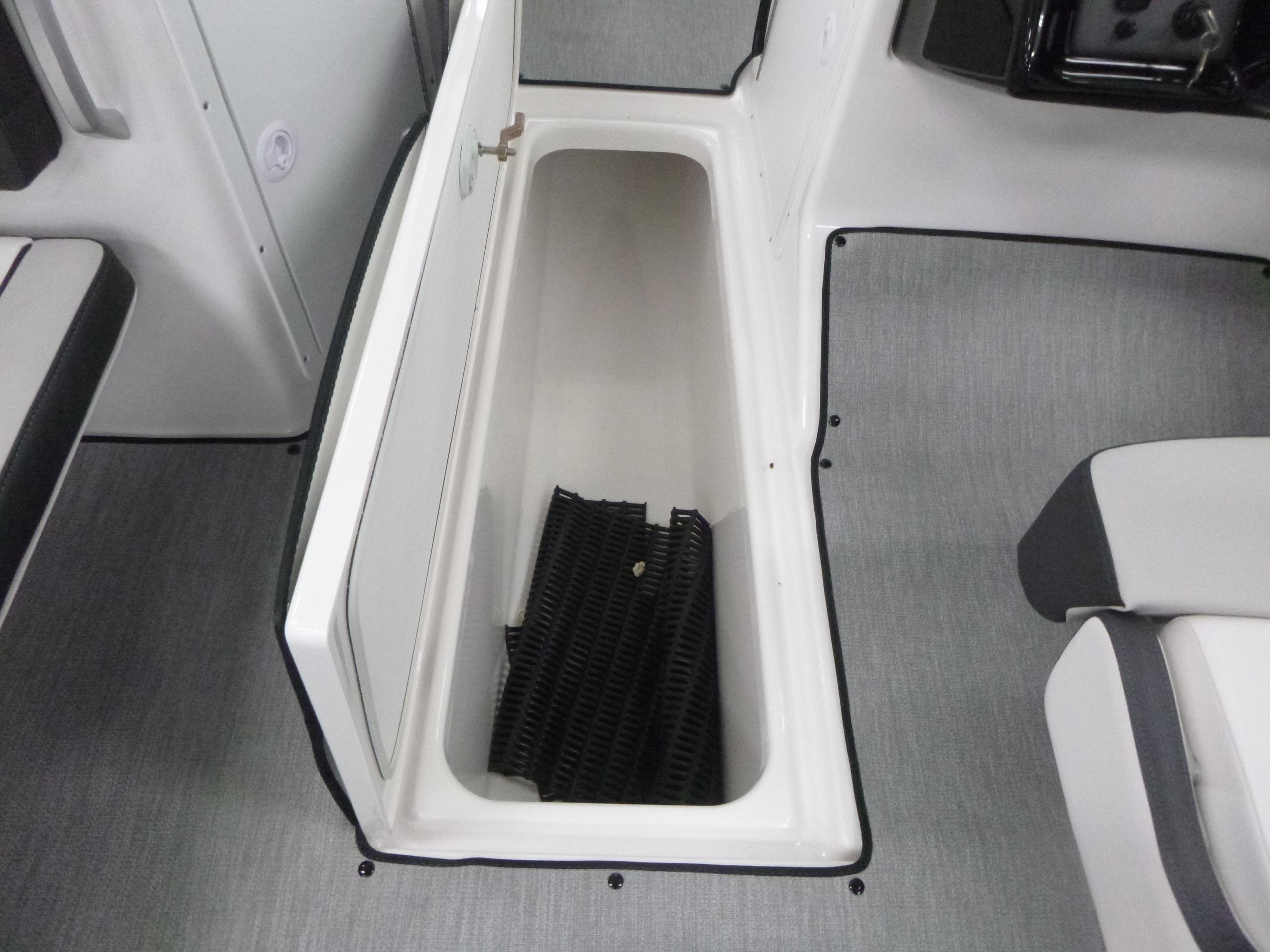 2025 Yamaha Boats AR195 storage compartment with open lid and interior mat.