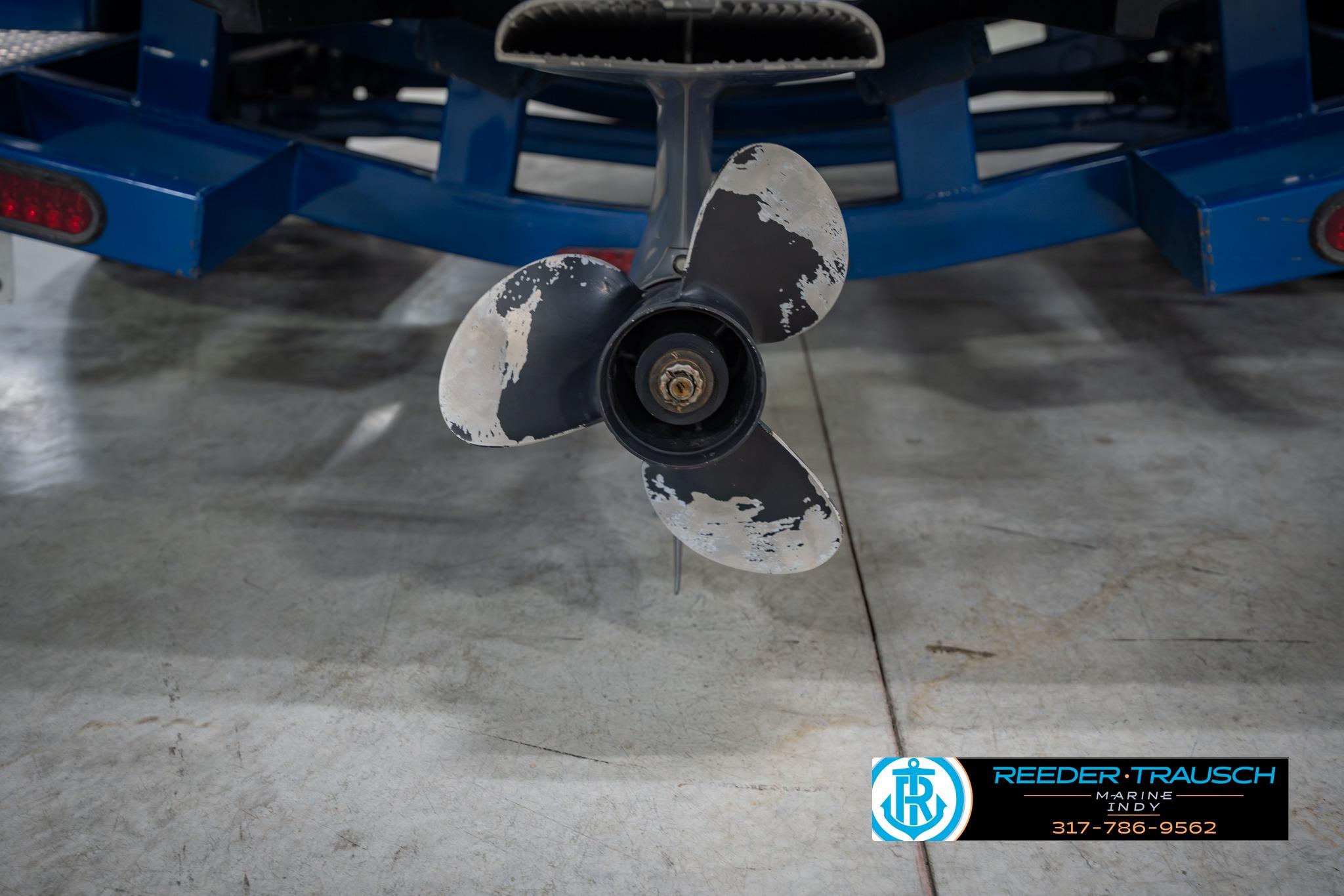Propeller of 2015 Regal 2000 ESX Bowrider on blue trailer in garage.