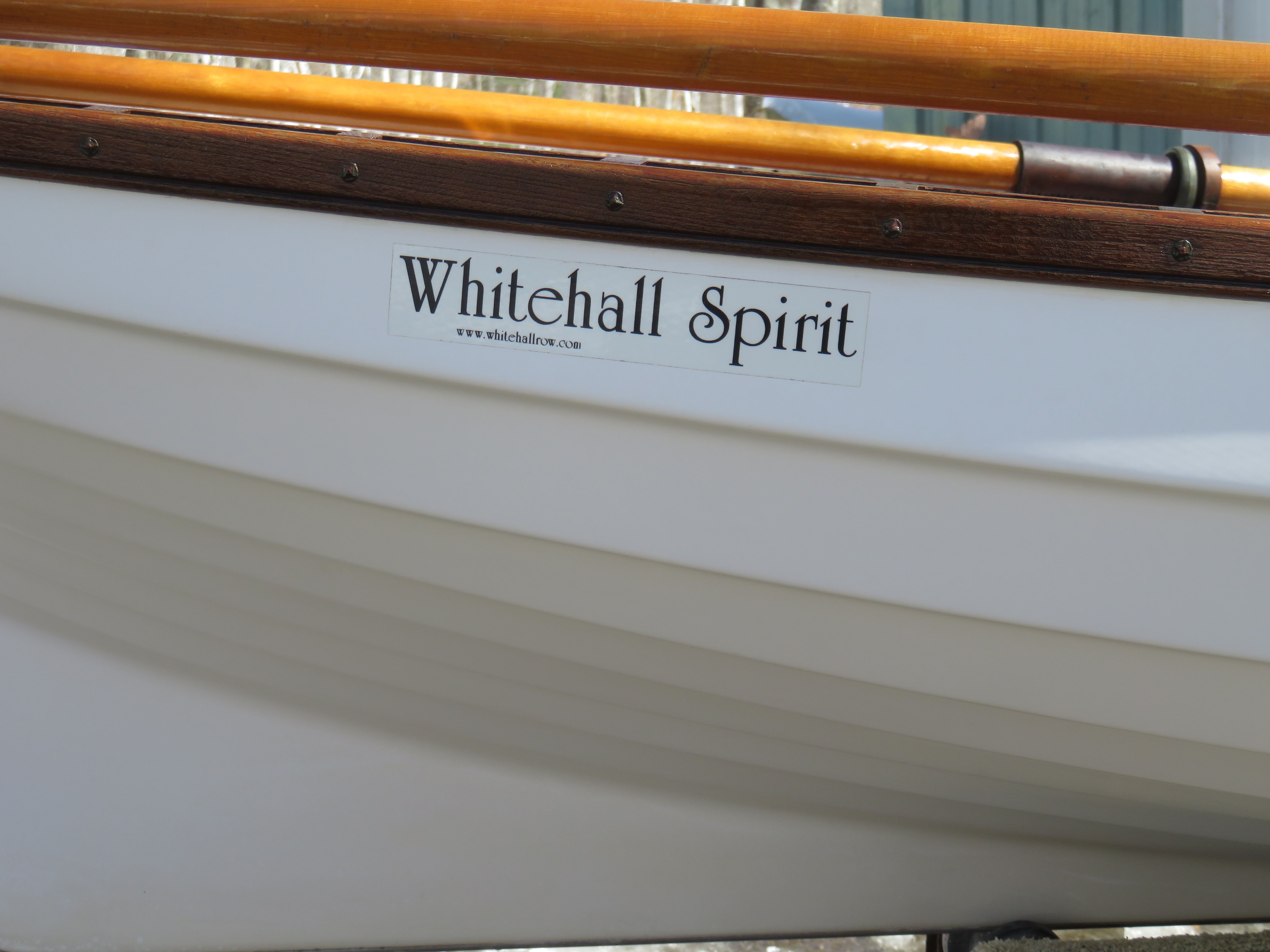 Close-up of a Whitehall Spirit 14 boat hull with wooden details.