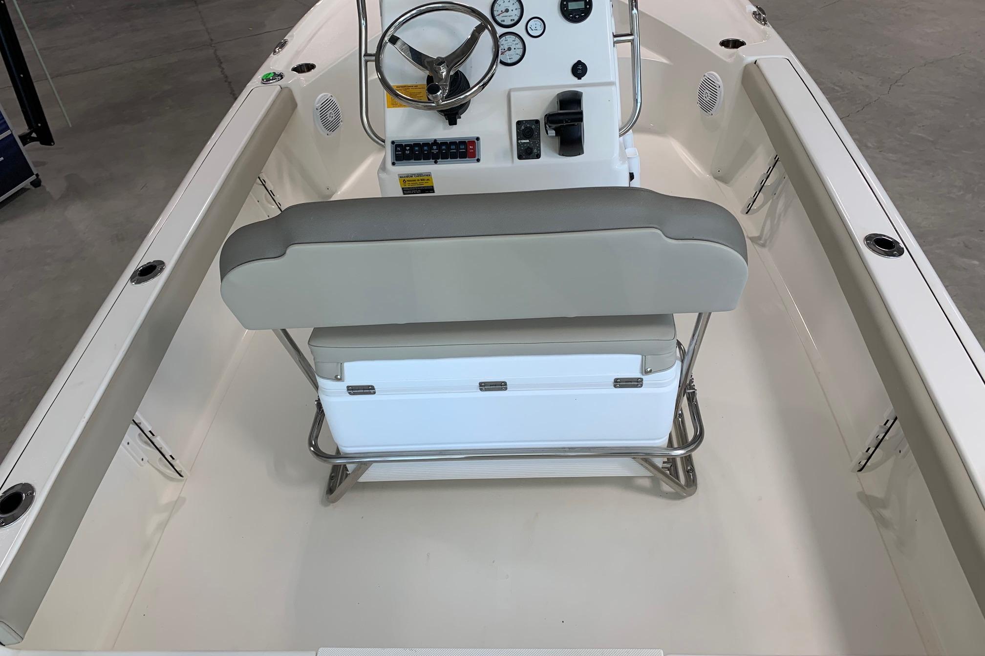 2026 Key West 188 Bay Reef boat interior with steering console and cushioned seating.