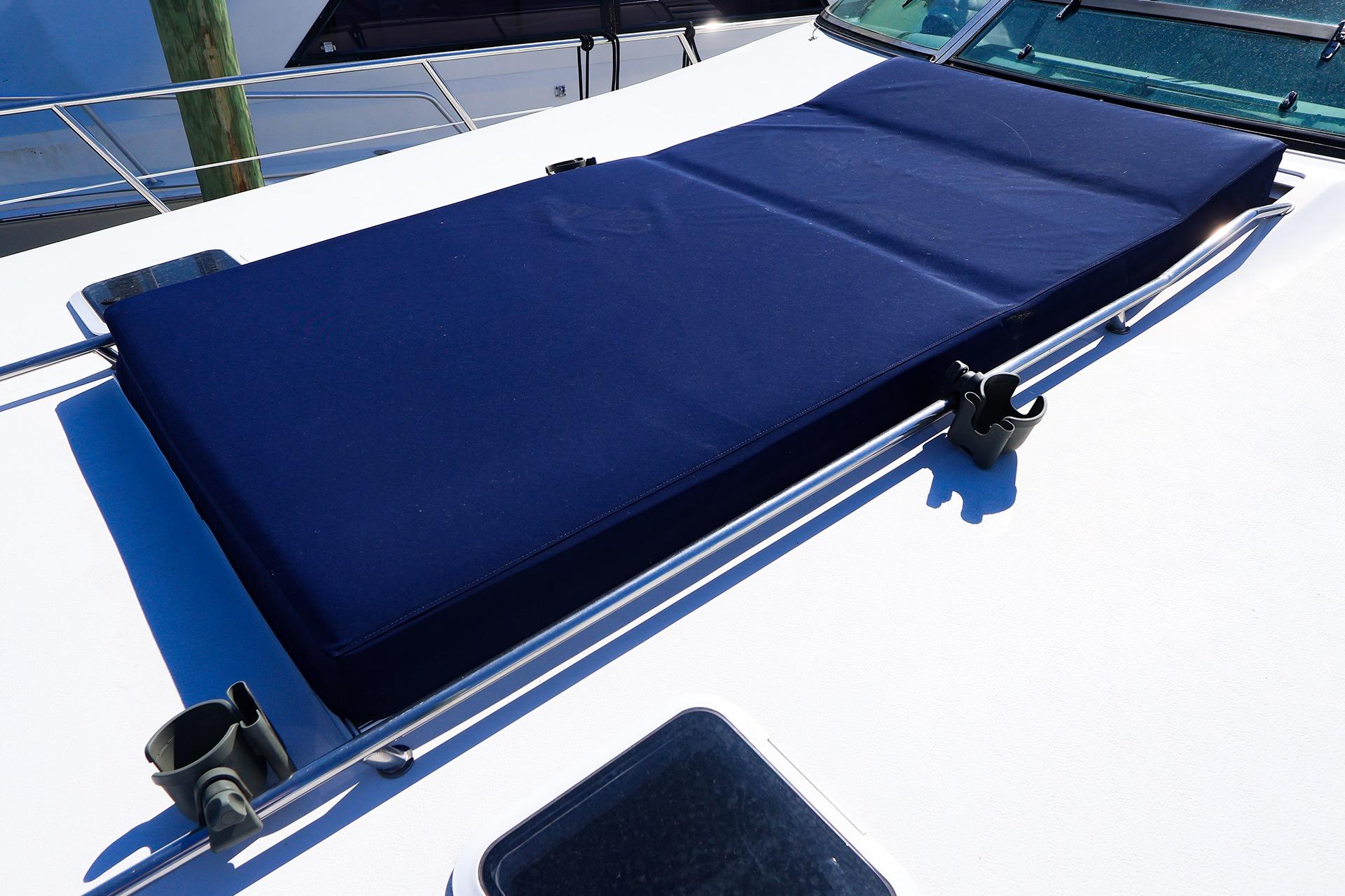Sunpad on 1998 Sea Ray 500 Sundancer yacht, featuring blue cushion and stainless steel railings.