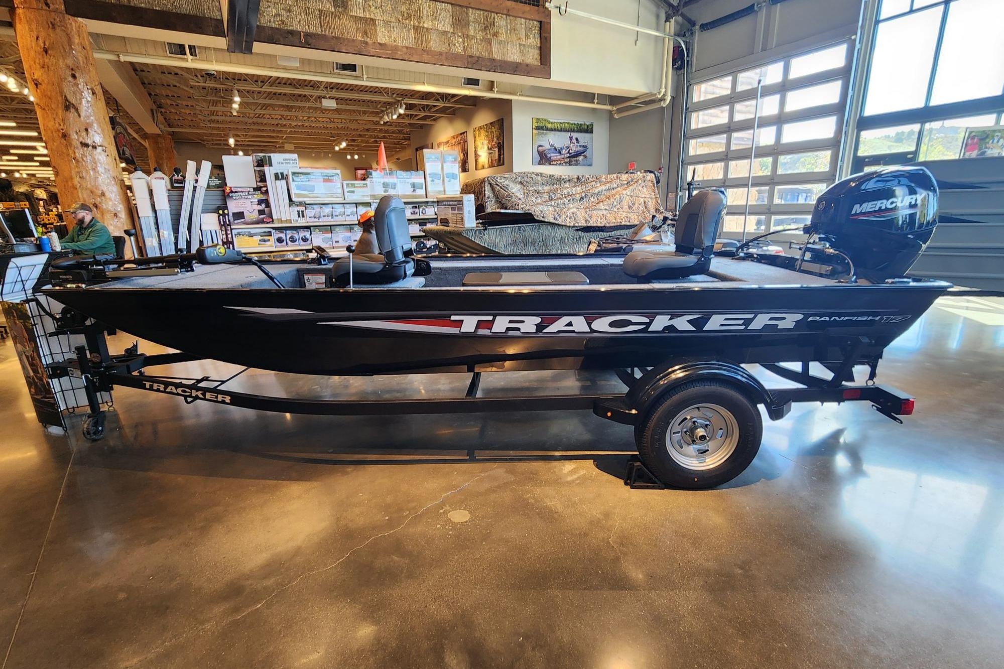 2026 Tracker Panfish 17 boat displayed indoors with Mercury engine.