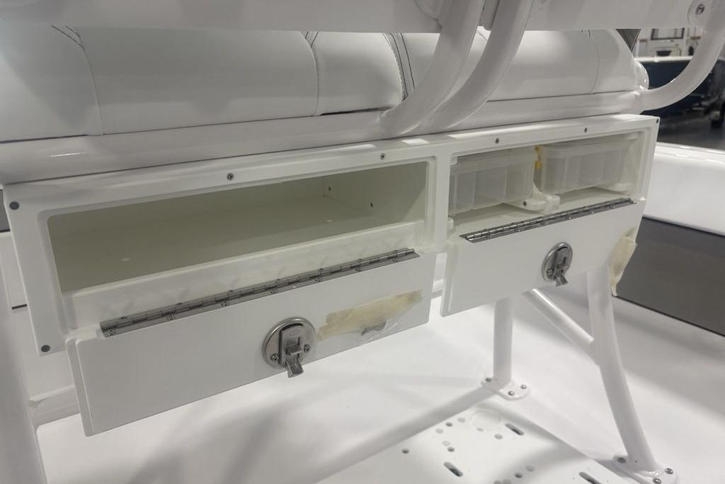 2026 Sportsman Masters 227 boat storage compartments with secure locks and white finish.