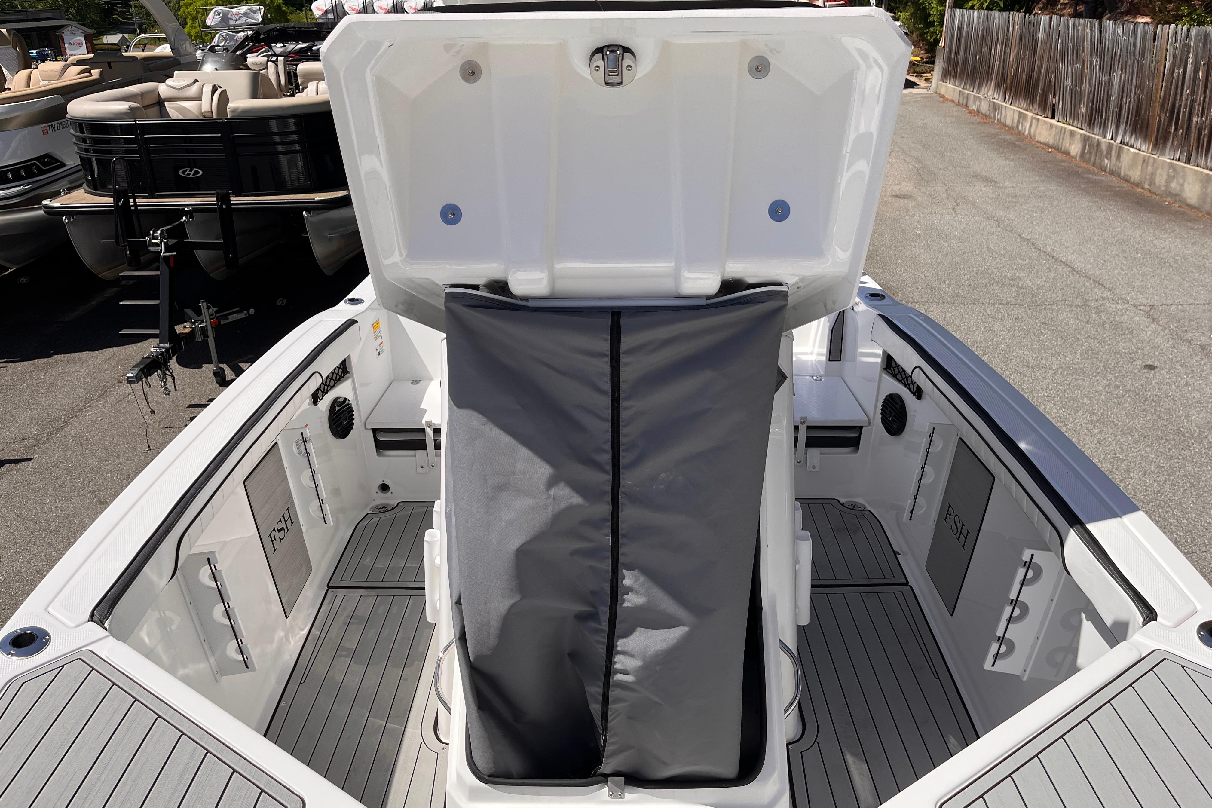 2026 Yamaha Boats 222 FSH Sport E interior with open storage compartment and sleek design.