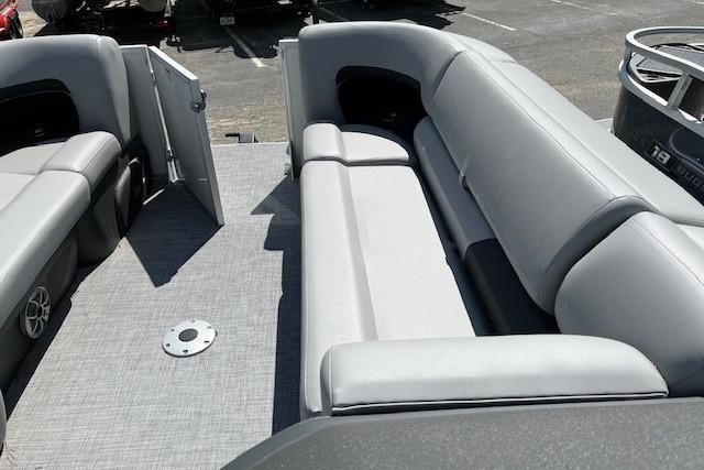 2026 Sun Tracker Party Barge 22 DLX interior with gray seating and open deck.