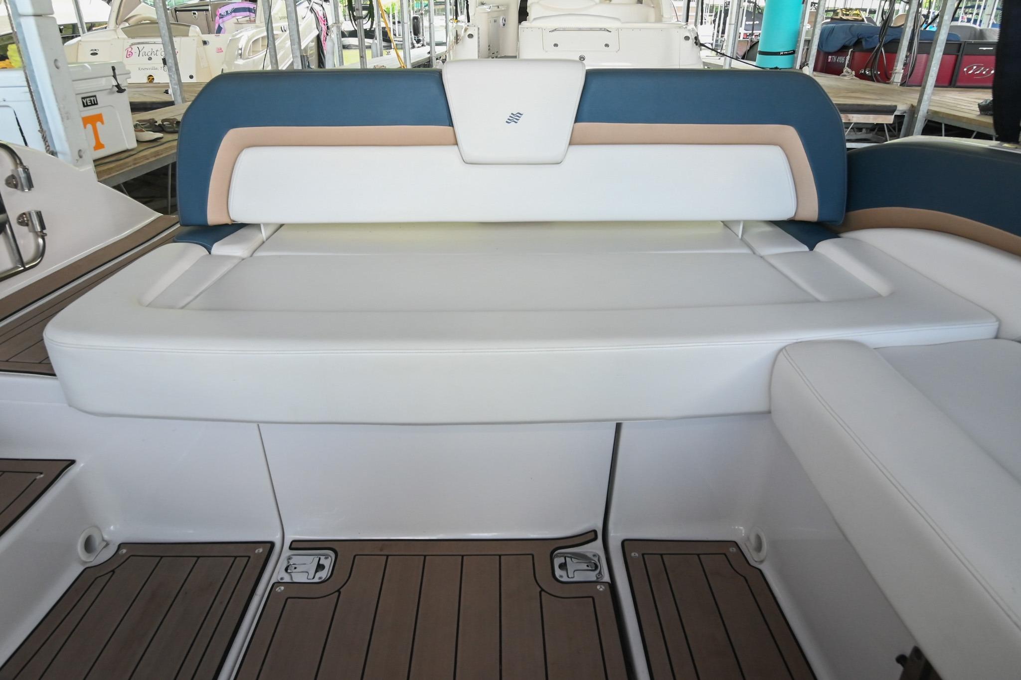 Interior seating of 2014 Four Winns H290 boat, featuring white and blue upholstery.