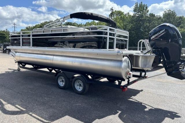 2026 Sun Tracker Fishin' Barge 22 DLX pontoon boat on trailer, featuring Mercury outboard motor.