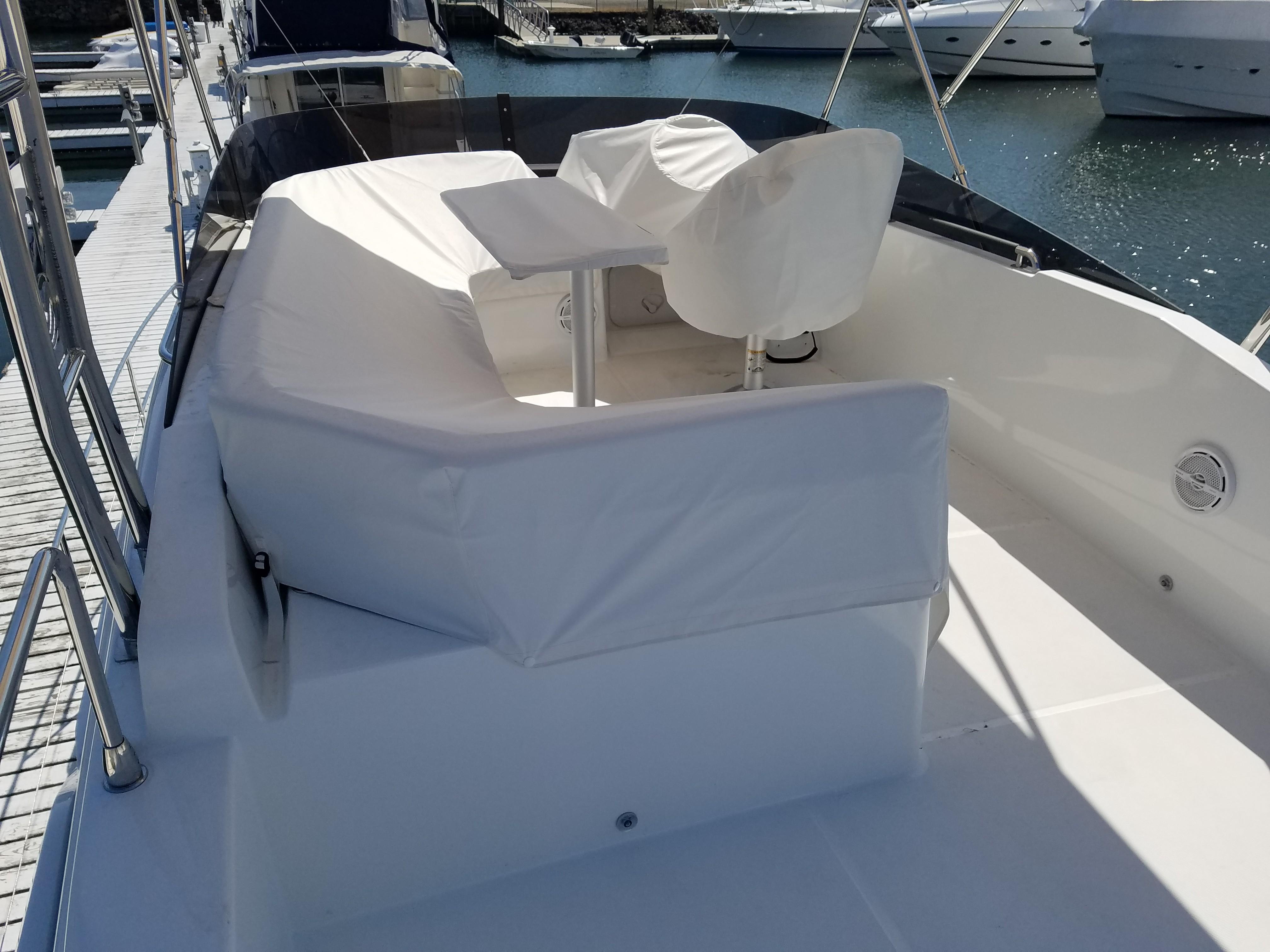 2019 Beneteau Swift Trawler 35, featuring a sleek deck with white seating and table.