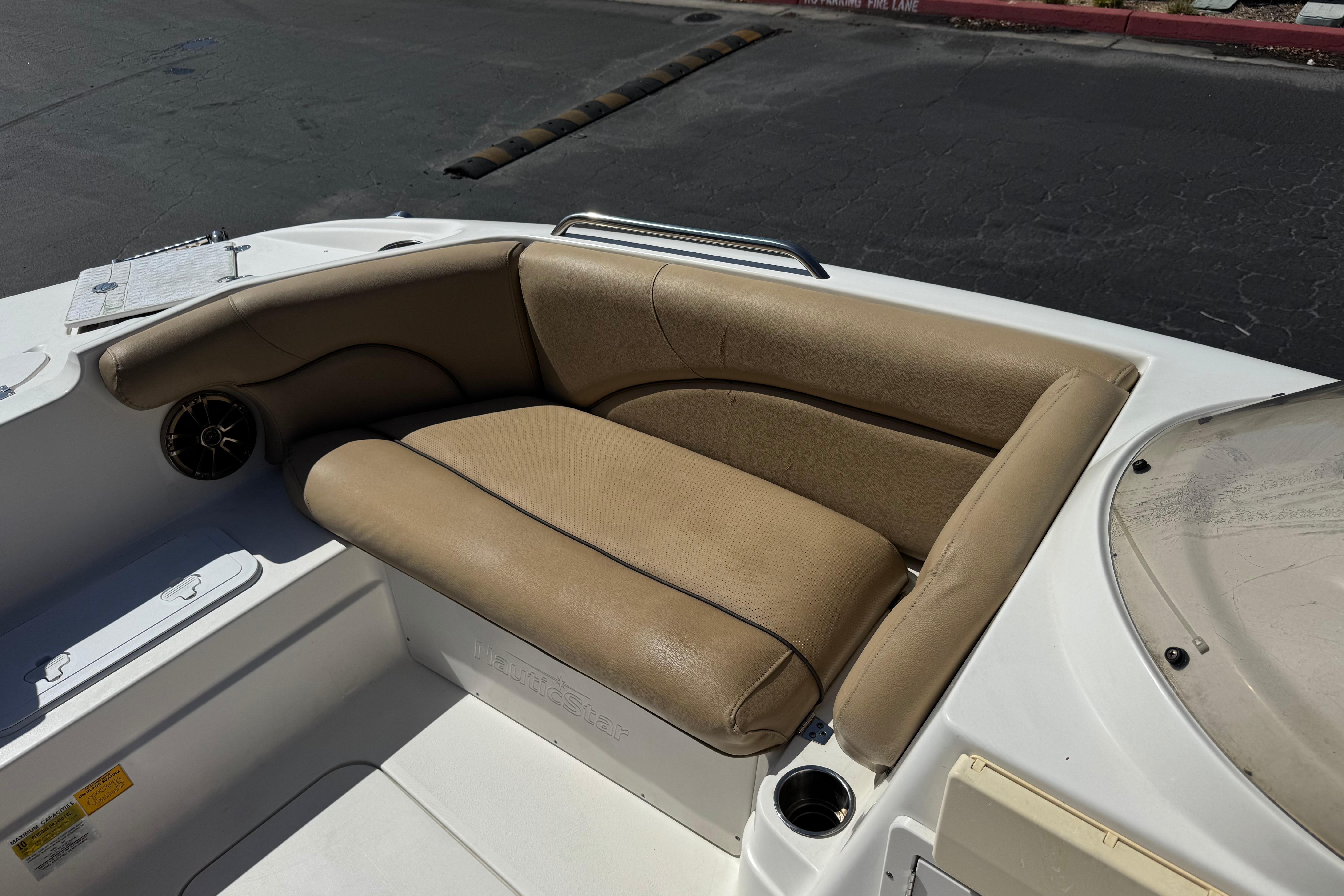 2020 NauticStar 203 SC boat interior with tan seating and cup holder.