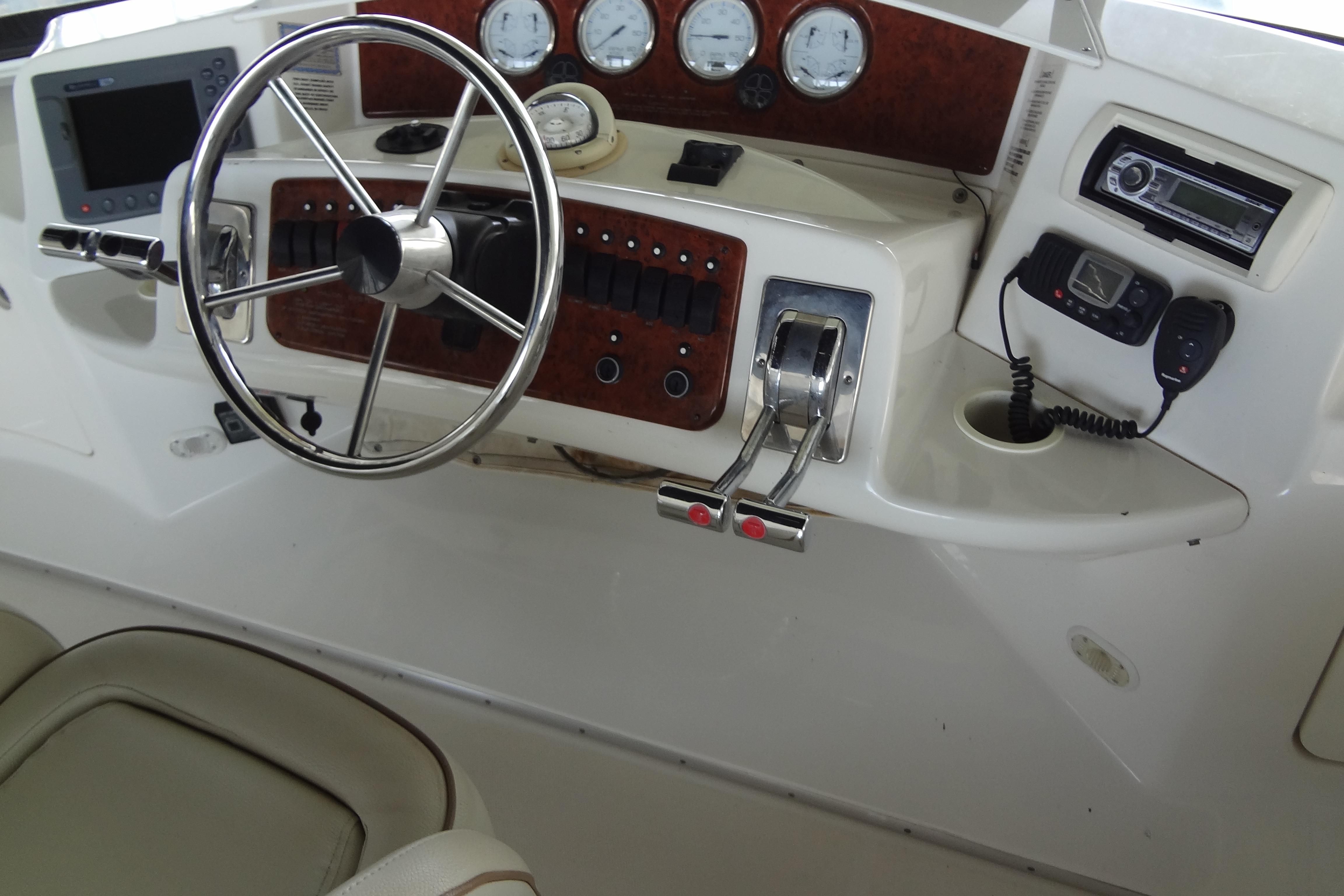 2005 Silverton 34 Convertible helm with steering wheel, gauges, and control panel.