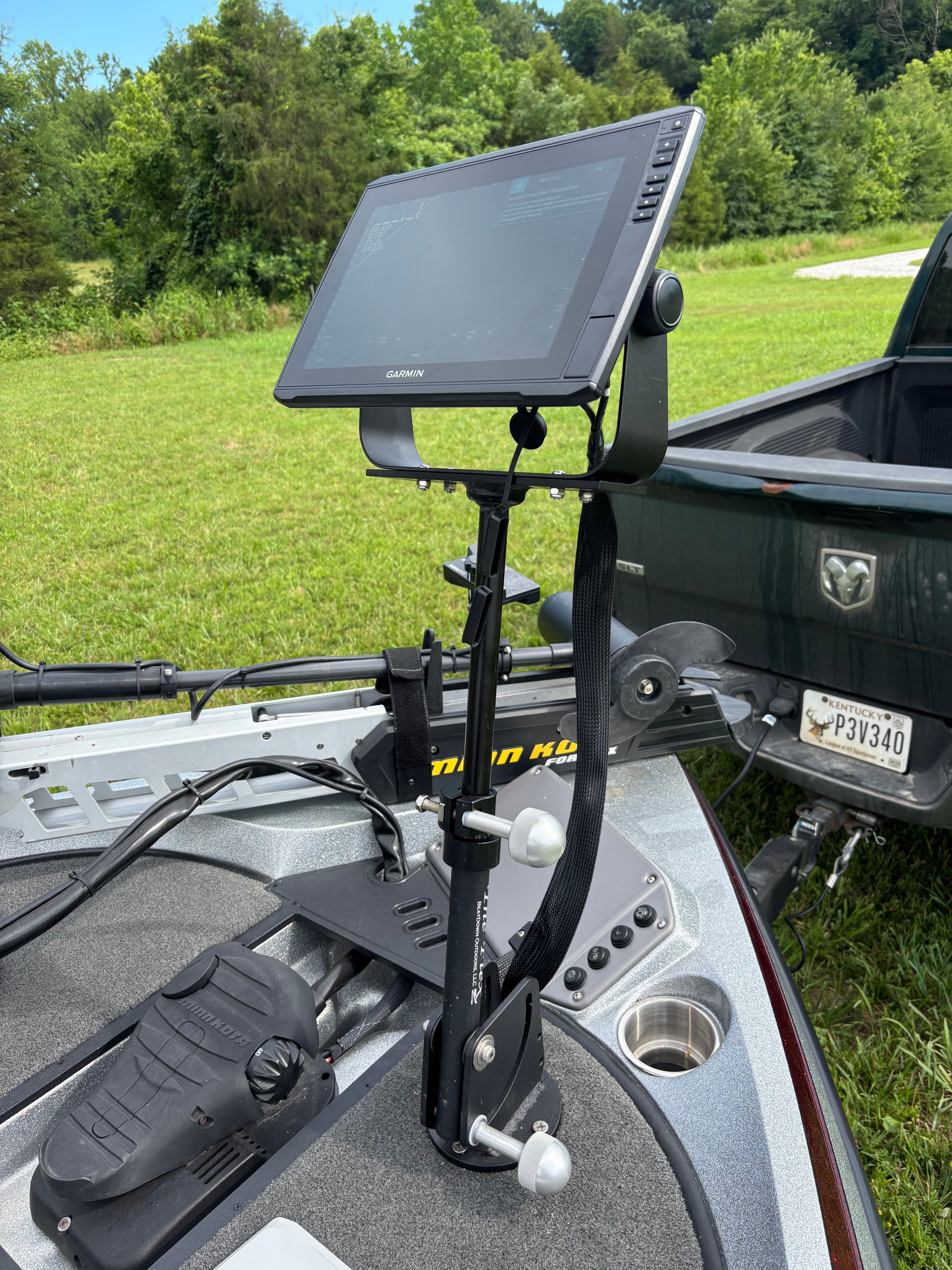 A boat with a mounted screen and pedals on the deck.