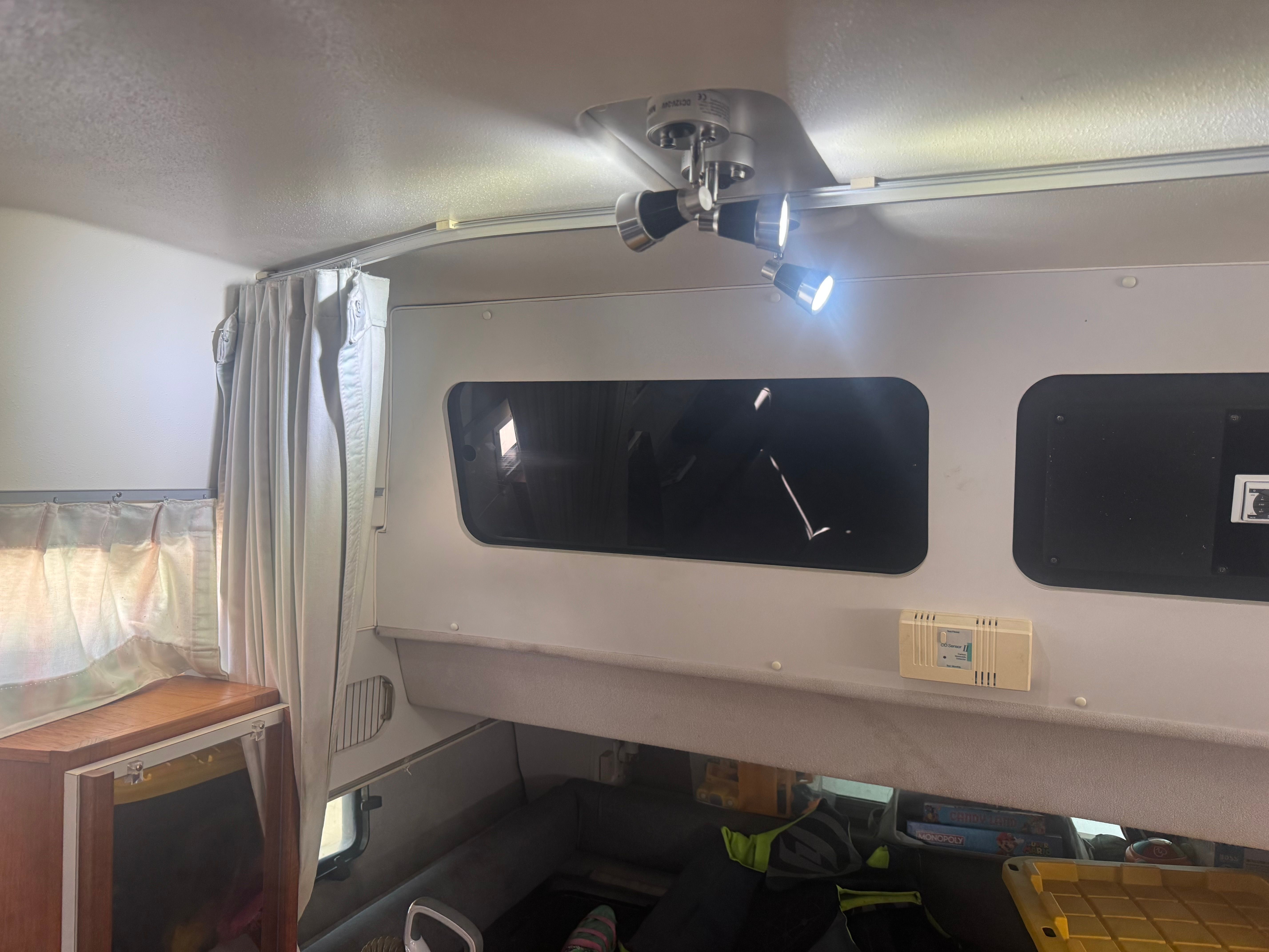 Interior of a 1992 Cruisers Yachts Esprit 3370 with curtains and lighting.