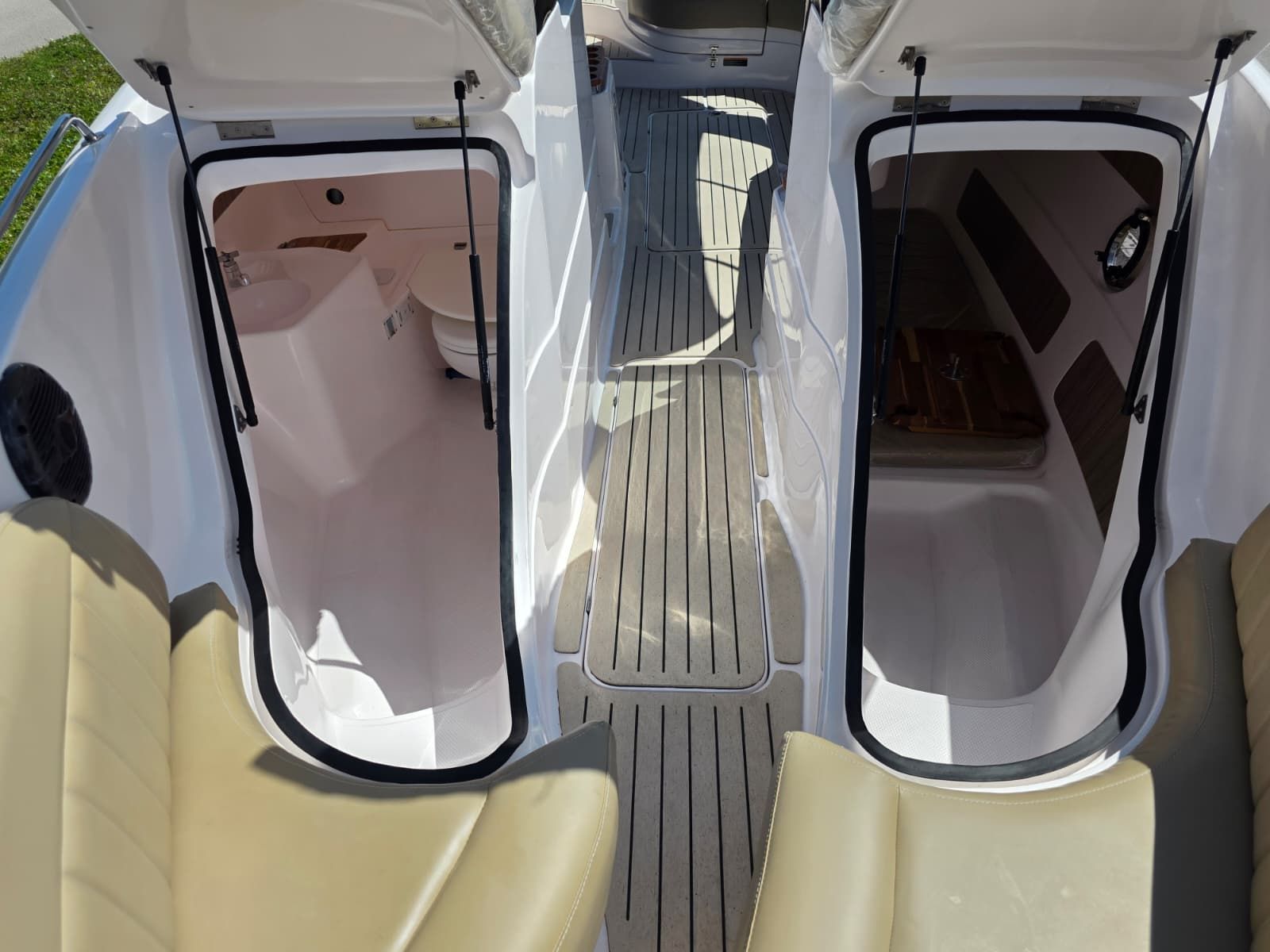 The image shows the cockpit of a Coral 26 boat with two open cabin doors.
