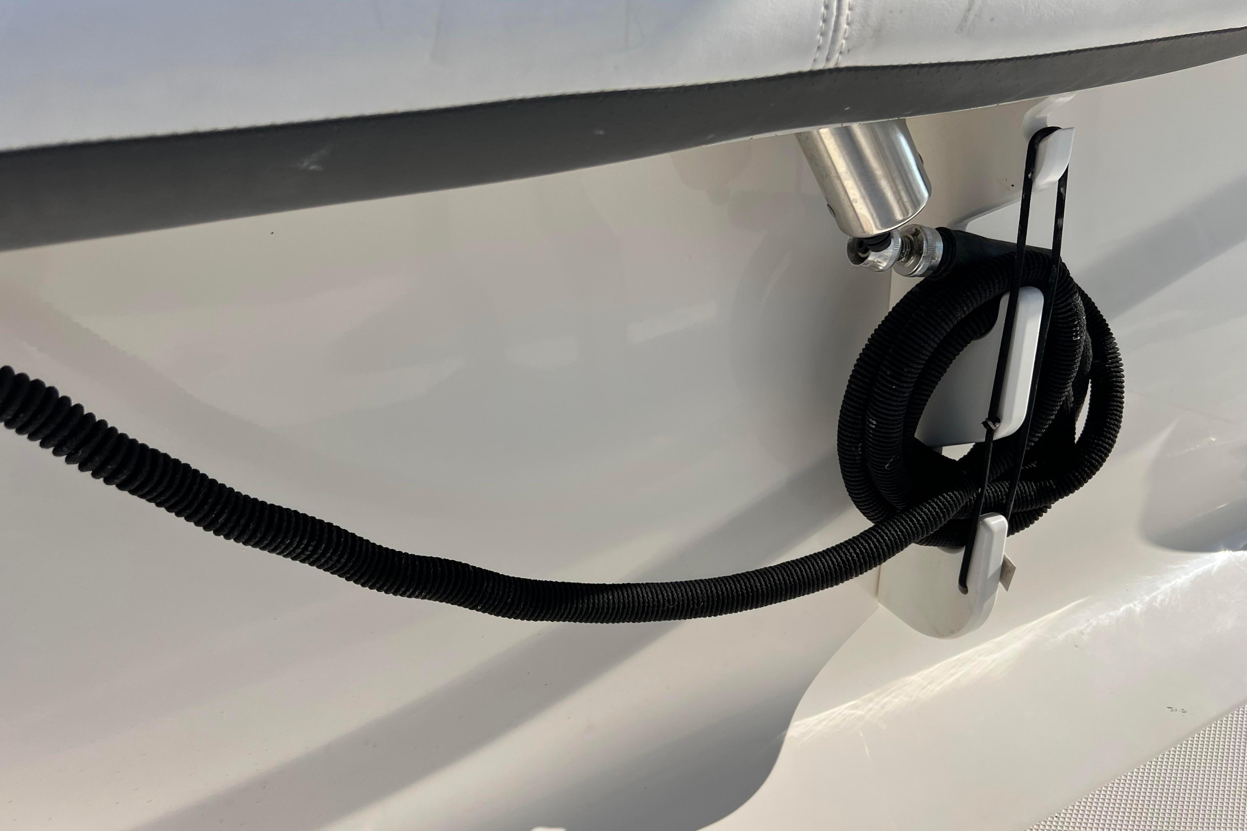 2012 Sea Fox 206 Center Console boat detail with coiled black hose and metal fitting.