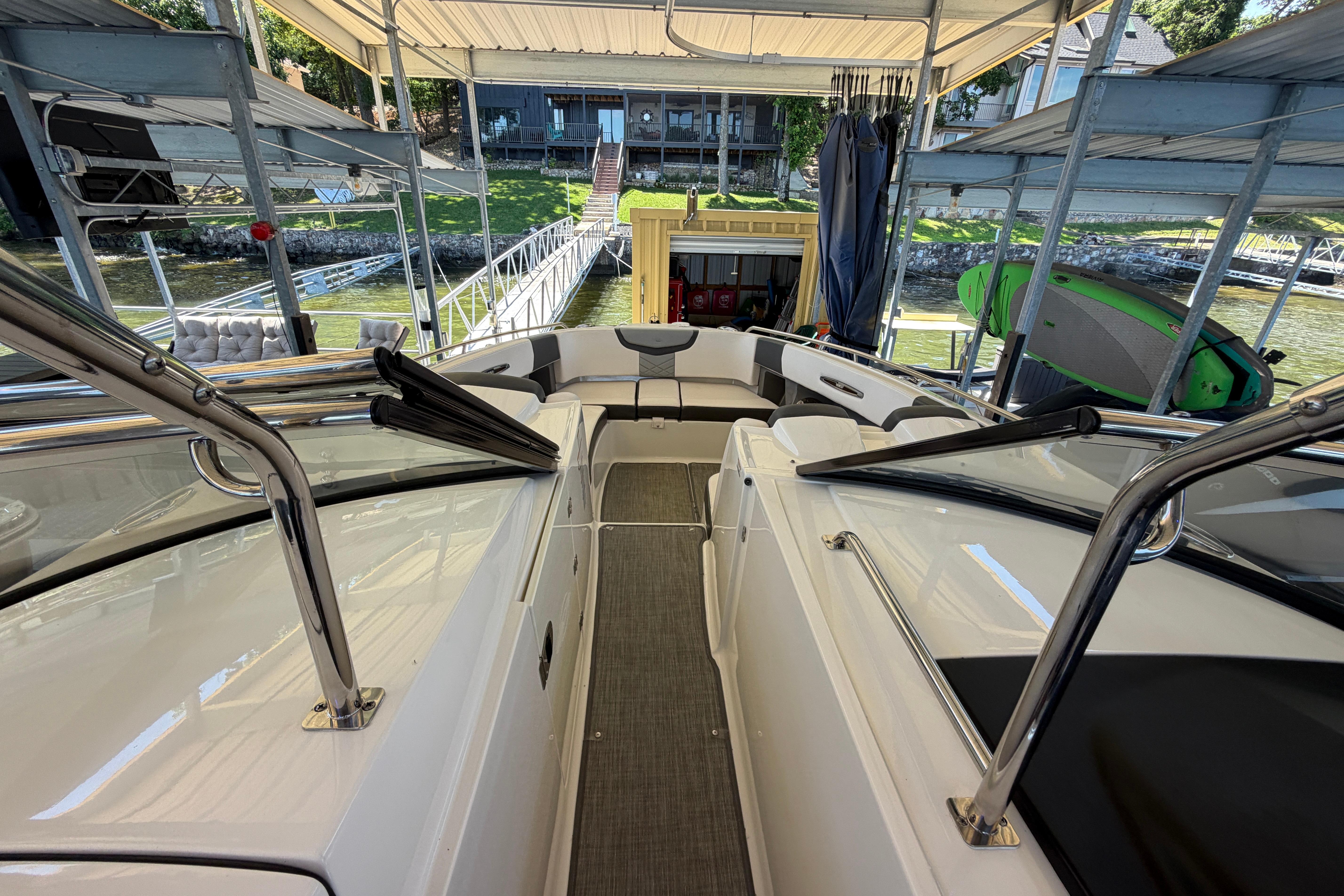 2018 Chaparral 347 SSX boat docked, showcasing spacious deck and seating area.