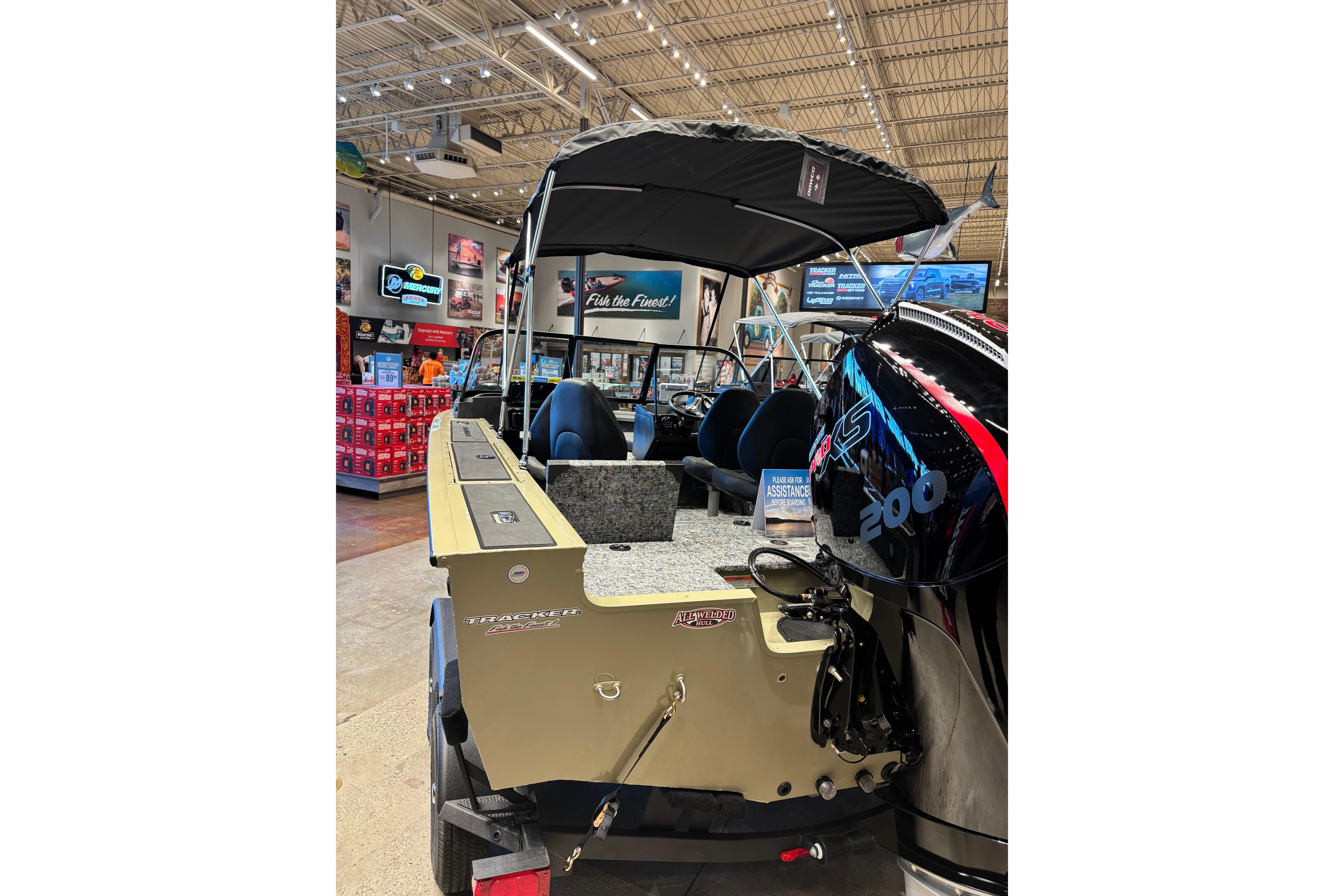 2026 Tracker Targa V-18 Combo boat displayed indoors with powerful outboard motor.