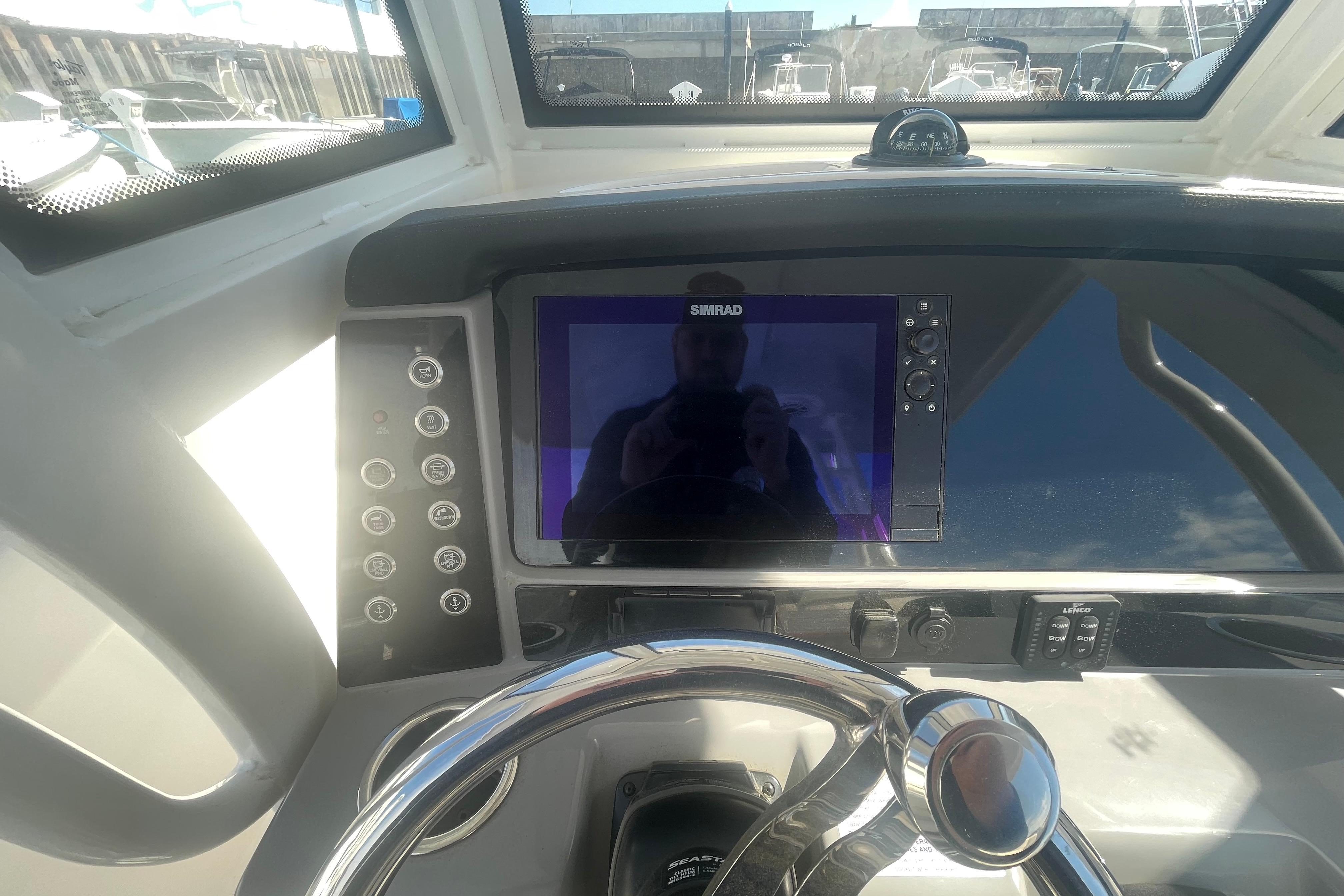 2023 Robalo R270 Center Console dashboard with Simrad display and steering wheel.