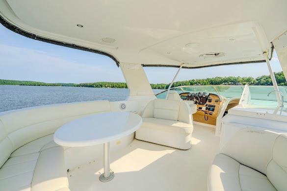 Luxurious 2003 Carver 570 Voyager Pilothouse yacht interior with scenic water view.