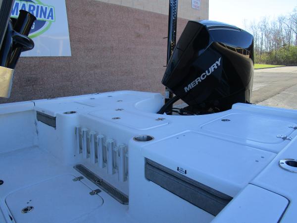 2025 Sea Pro 230 Bay boat with Mercury engine, docked outdoors.