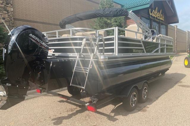 2025 Ranger Reata 223FC pontoon boat with Mercury engine, parked outside Cabela's.