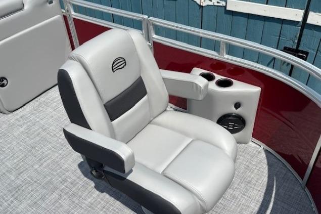 Luxury seating on 2026 Sun Tracker SportFish 20 DLX pontoon boat, featuring cup holders and speaker.