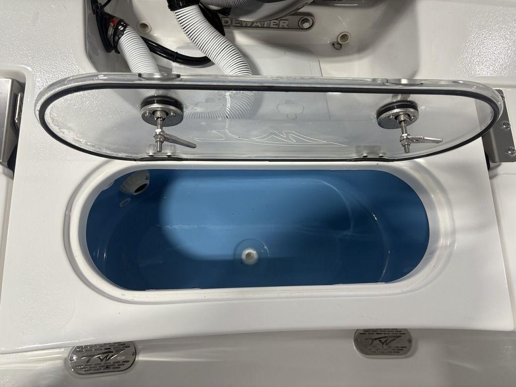 2026 Tidewater 2110 BM boat livewell with open lid, showcasing interior design.