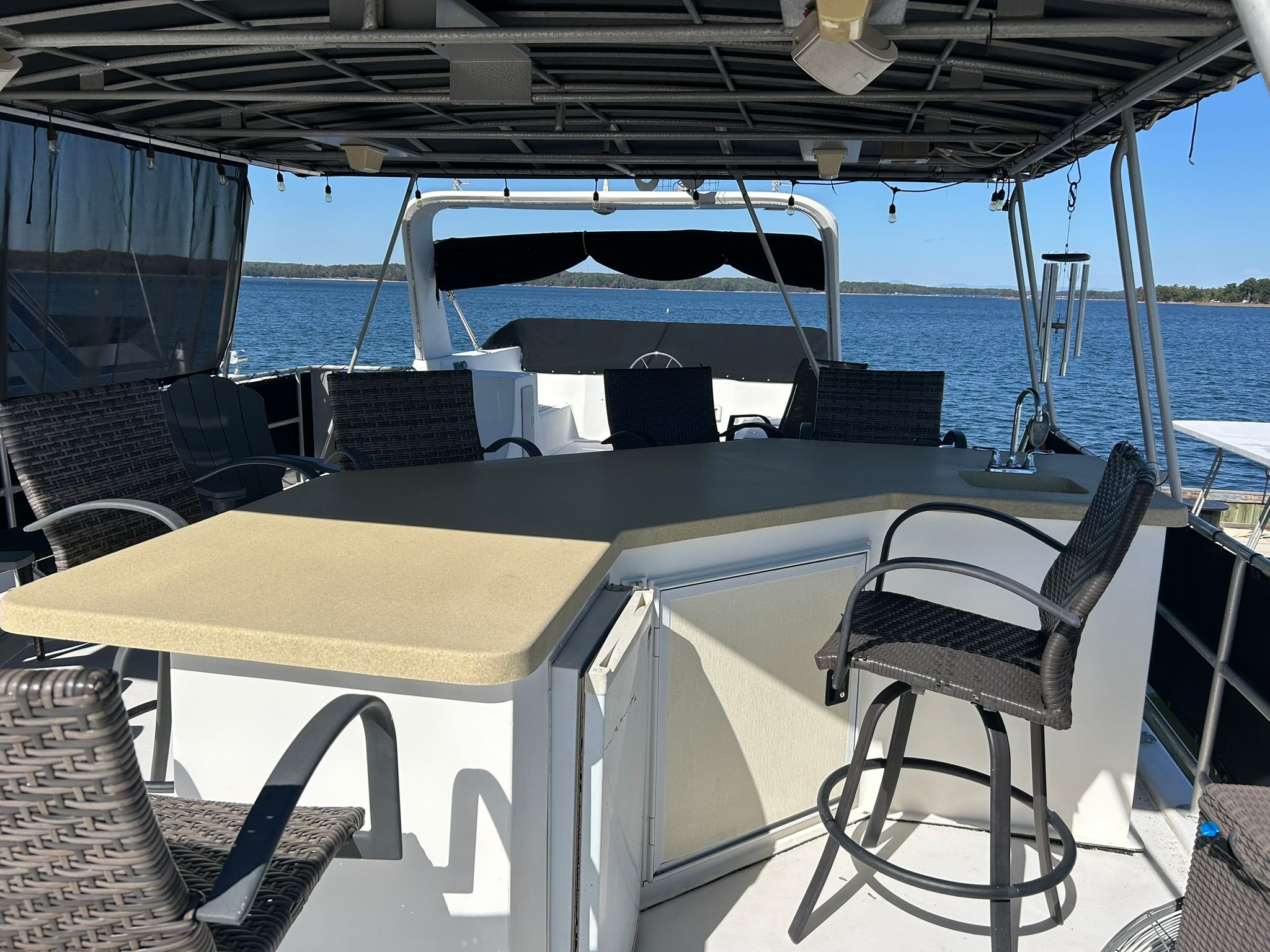 2001 Sumerset Houseboat with deck and seating area on the water.