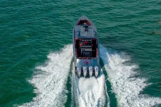 2021 Concept 44' Open Deck boat cruising on open water, rear view.