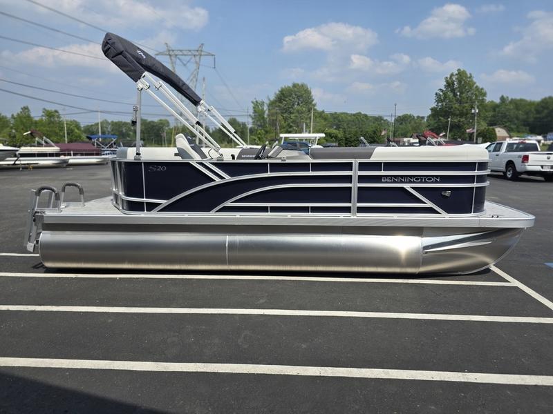 2025 Bennington 20 SL pontoon boat parked in a lot, featuring sleek design and modern amenities.