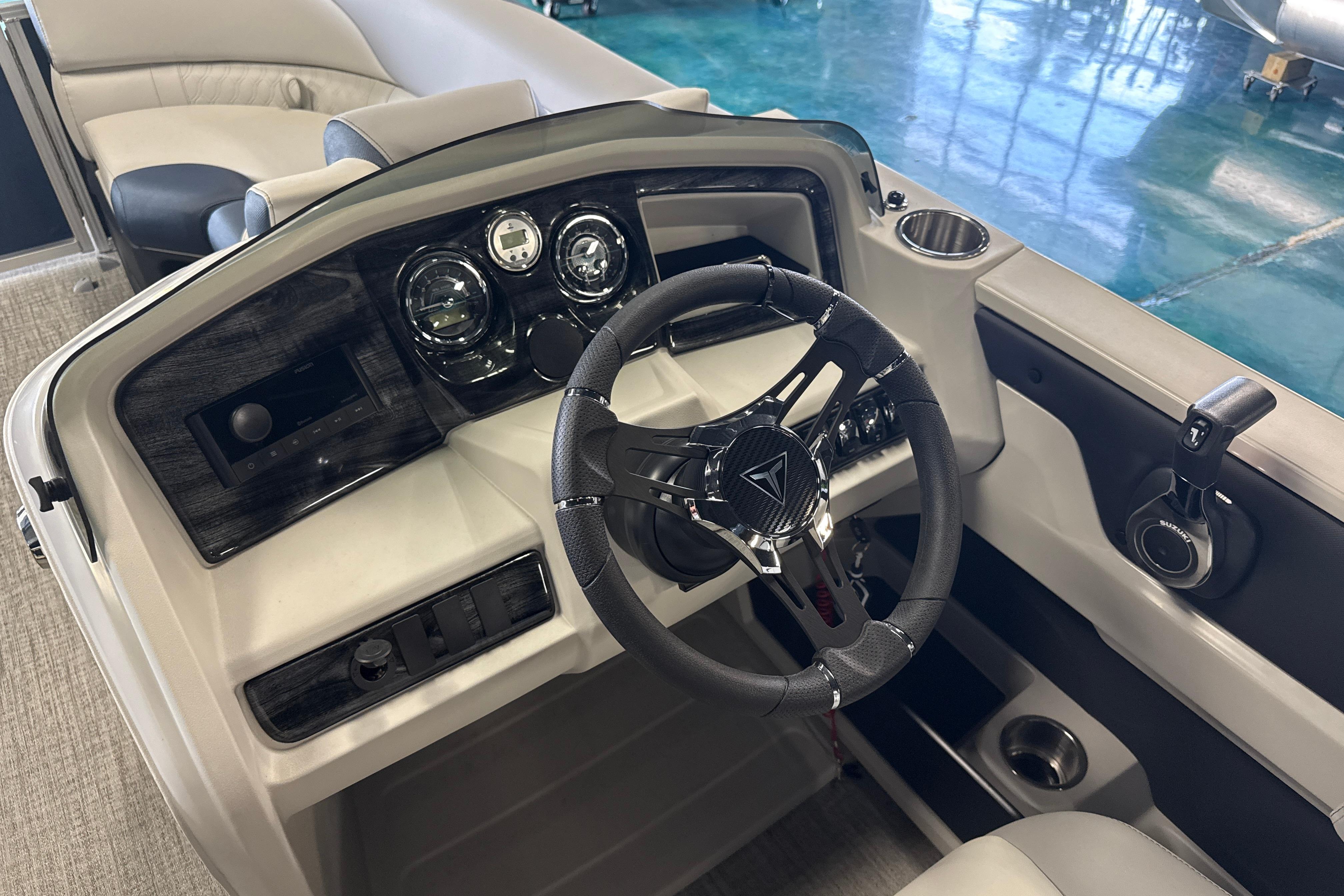2026 Tahoe Pontoon LTZ Quad Lounger dashboard with steering wheel and controls.