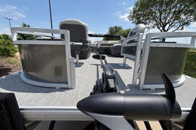 2026 Sun Tracker Bass Buggy 16 XL Select pontoon boat, spacious deck, outdoor setting.
