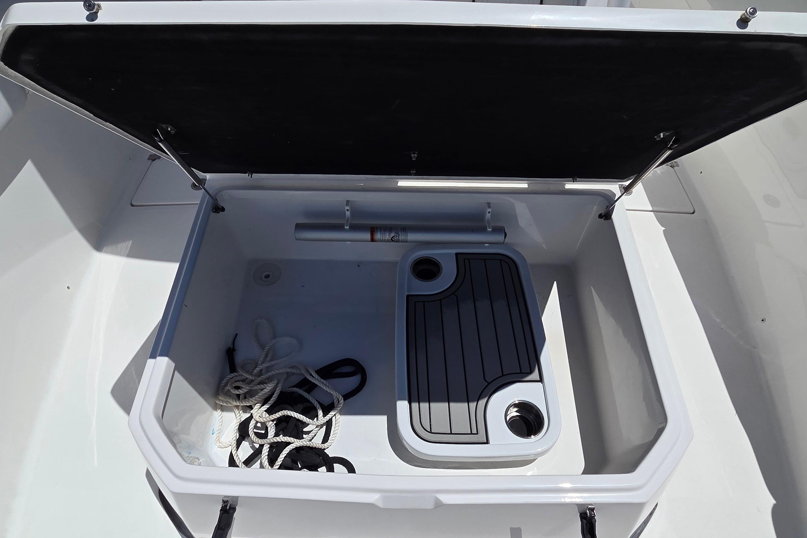 Open storage compartment on 2021 Sea Fox 328 Commander boat with ropes inside.